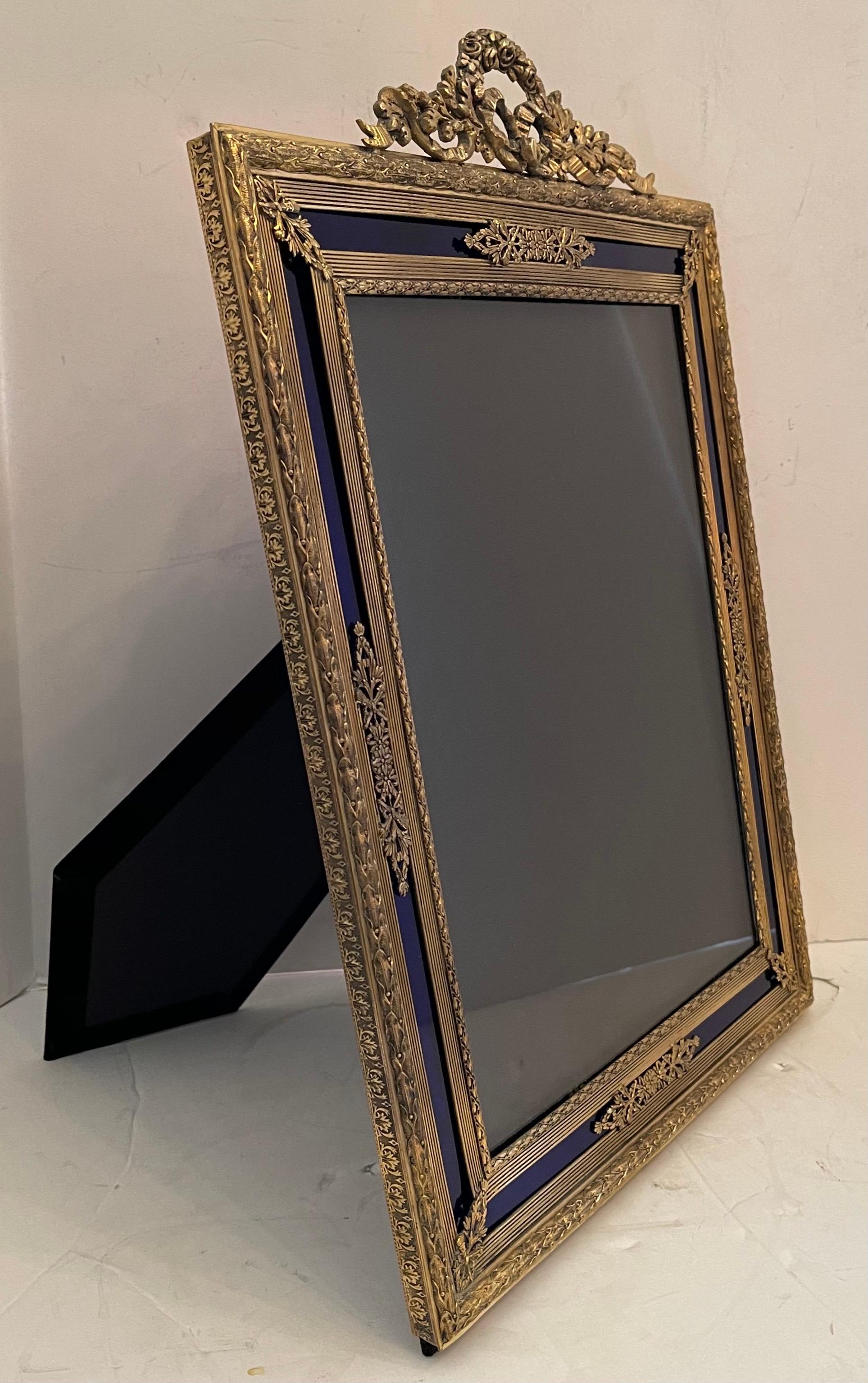 A wonderful large French Louis XVI ormolu bronze & blue glass inset picture frame with wreath & garland crown.