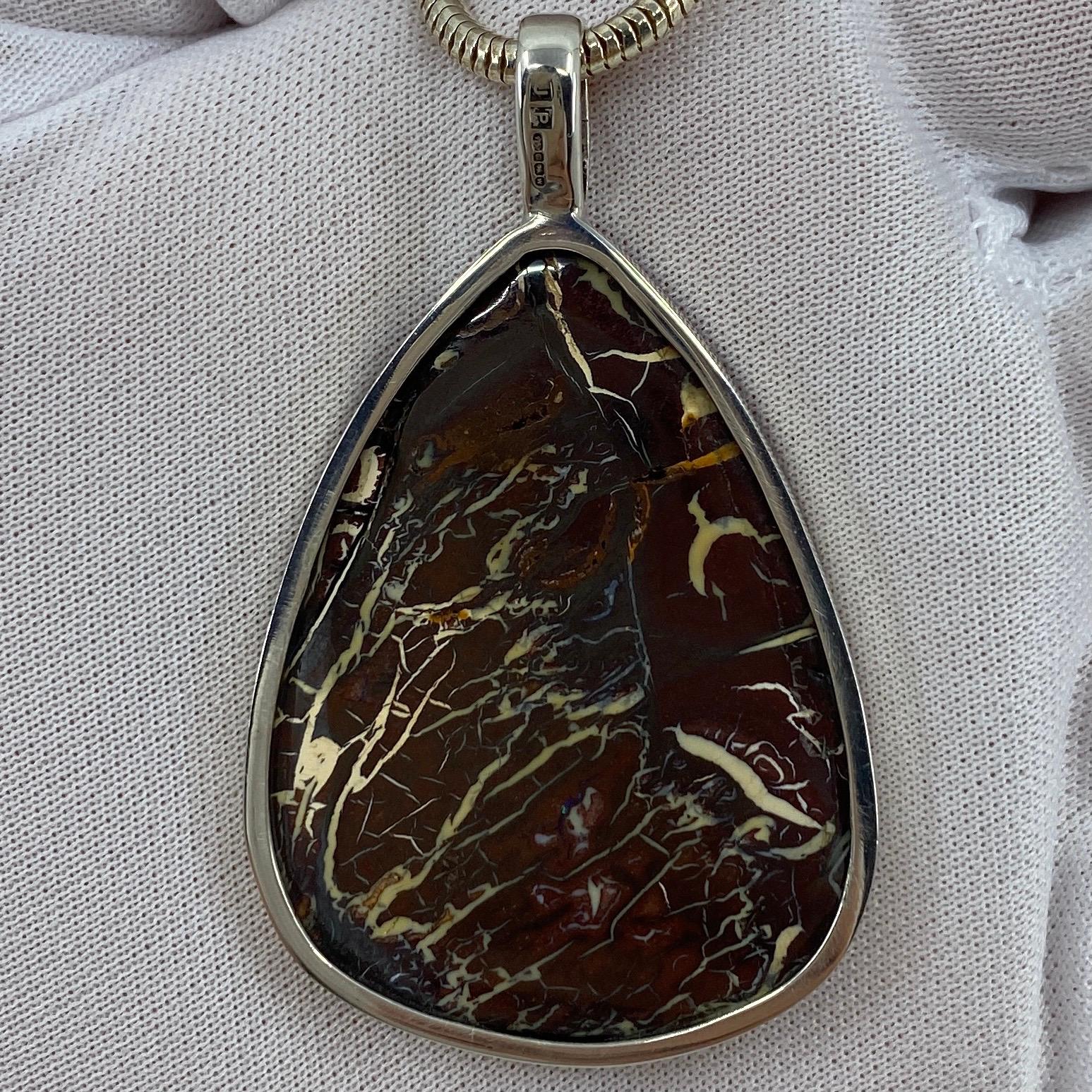 Fine Handmade Large Natural Boulder Opal Pendant Necklace.

Large beautiful natural boulder opal pendant weighing 18.3g. Handmade in sterling silver.

Hanging on an 24' snake chain.

A unique piece.

The pendant is brand new and never