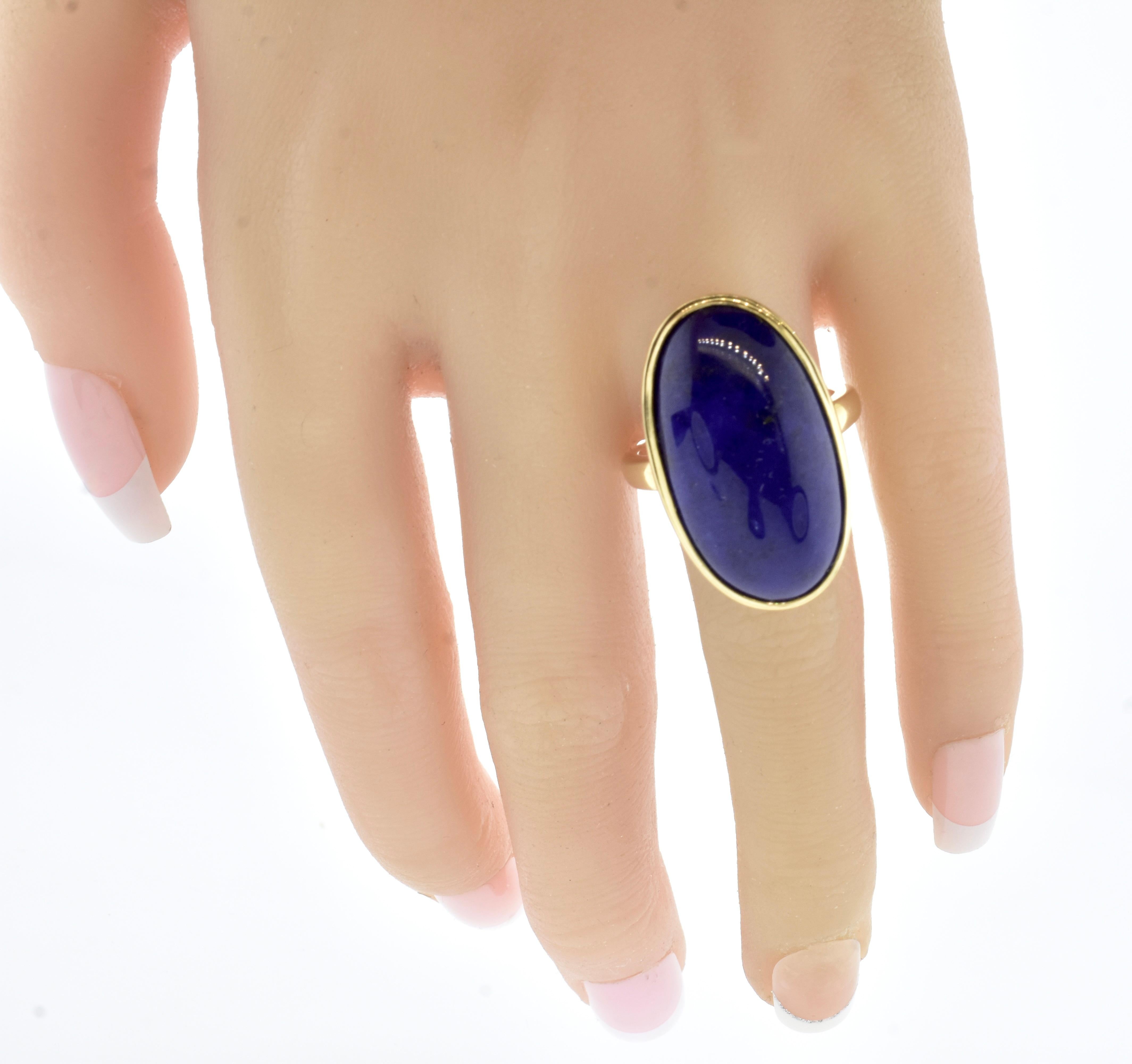 Fine Vivid Blue Lapis Lazuli and yellow gold ring.  This fine lapis is estimated to weigh 25.5 cts. It is a deep vivid blue with tiny gold flecks - endemic to fine lapis lazuli.  

The long oval is a very complimentary shape to the finger, this ring
