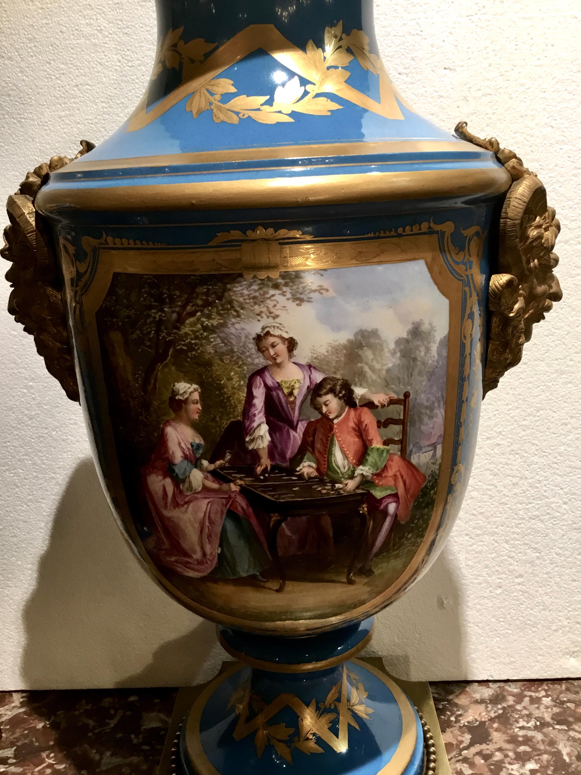Large pair of Sèvres vases in Bleu Celeste of baluster form with courting scenes in a
Garden painted on the fronts and a forest scene painted on the reverse side.