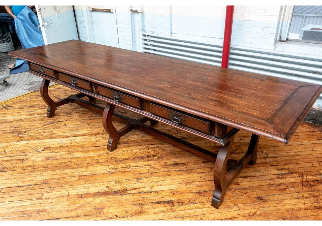 Very large and exceptional Refectory Table believed to be Italian. With a rectangular banded overhanging top and three curved shaped supports with block feet. A long stretcher on the base connecting the supports with three cross stretchers. One long