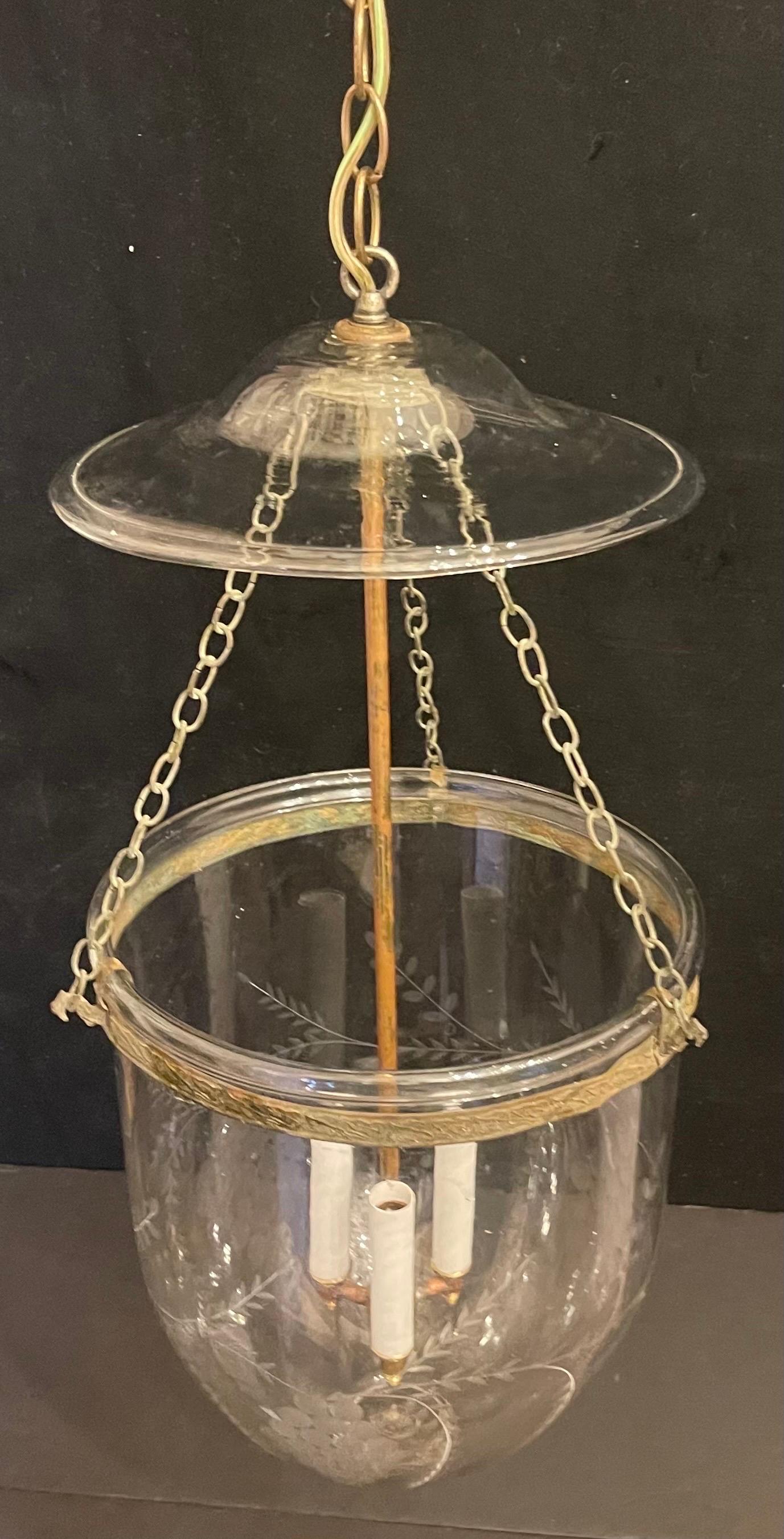 A fine large bell jar etched grapes and vines blown glass with bronze / brass rim in the neoclassical motif, this beautiful lantern fixtur has 3 candelabra lights on the inside and comes with chain canopy and mounting hardware
in the manner of