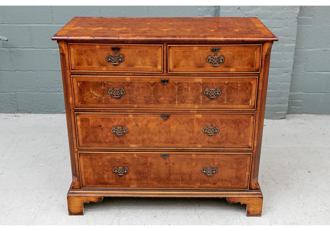 A particularly fine Antique presumed English Chest with magnificent color and style. A finely made chest with book matched Yew burl wood sections forming patterns on the top and drawers. The banded top with carved and pieced bull nose edge. The case