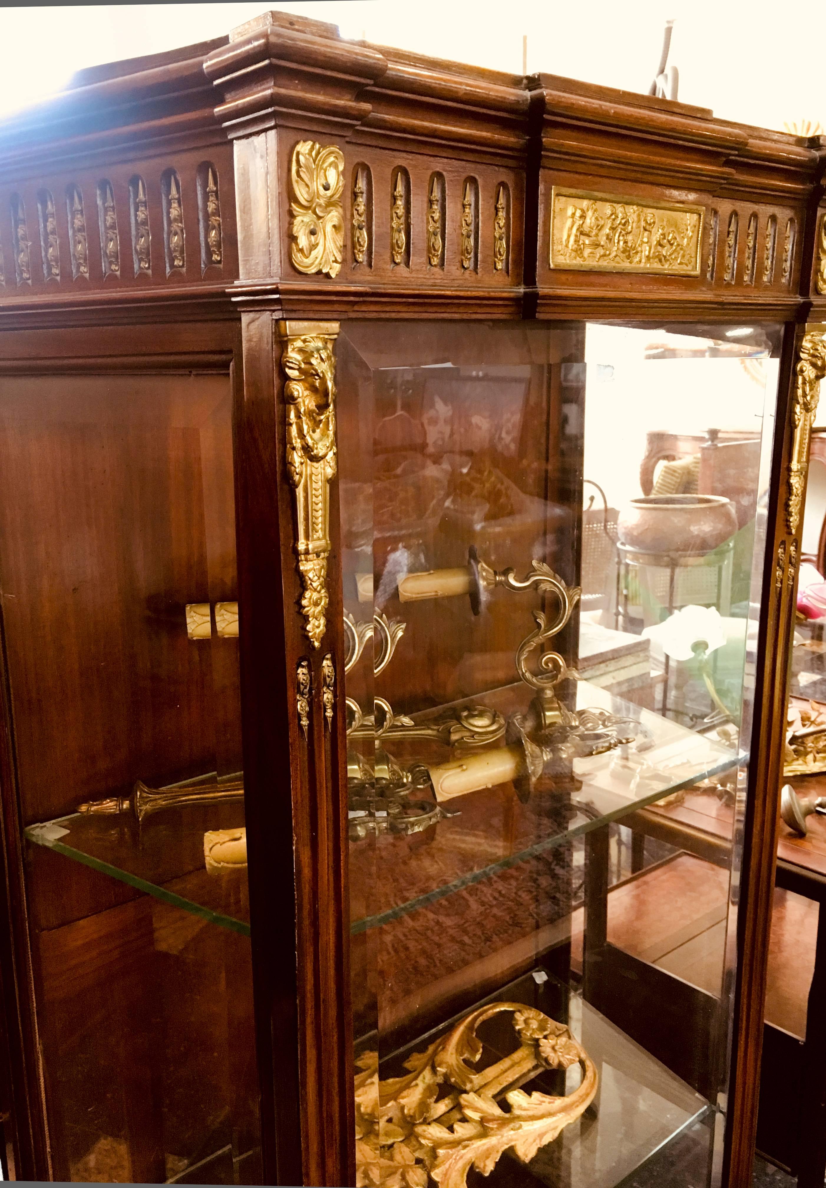 A late 19th century Louis XVI style gilt bronze-mounted marquetry vitrine with side door.
France, circa 1880.