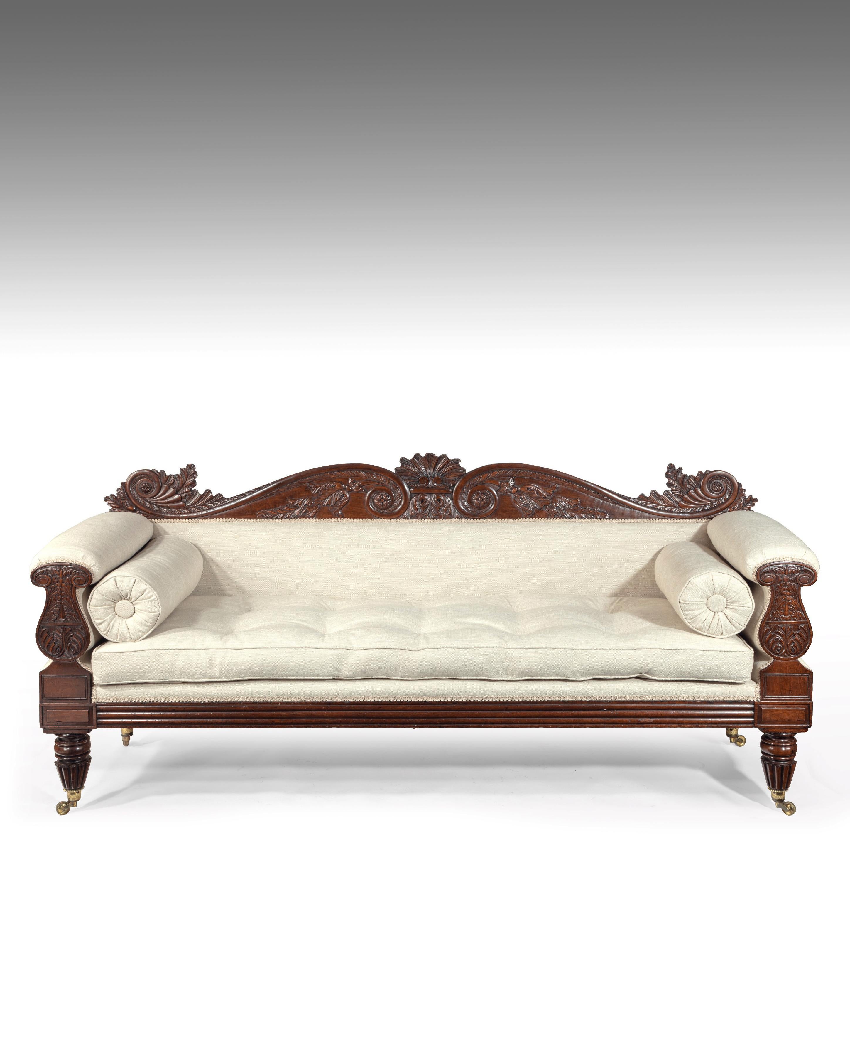 A fine quality late Regency / William IV mahogany sofa newly upholstered in a high quality neutral coloured linen, after a design by John Taylor.

English, circa 1830.

The fine foliate and acanthus leaf carved double scrolled top rail with