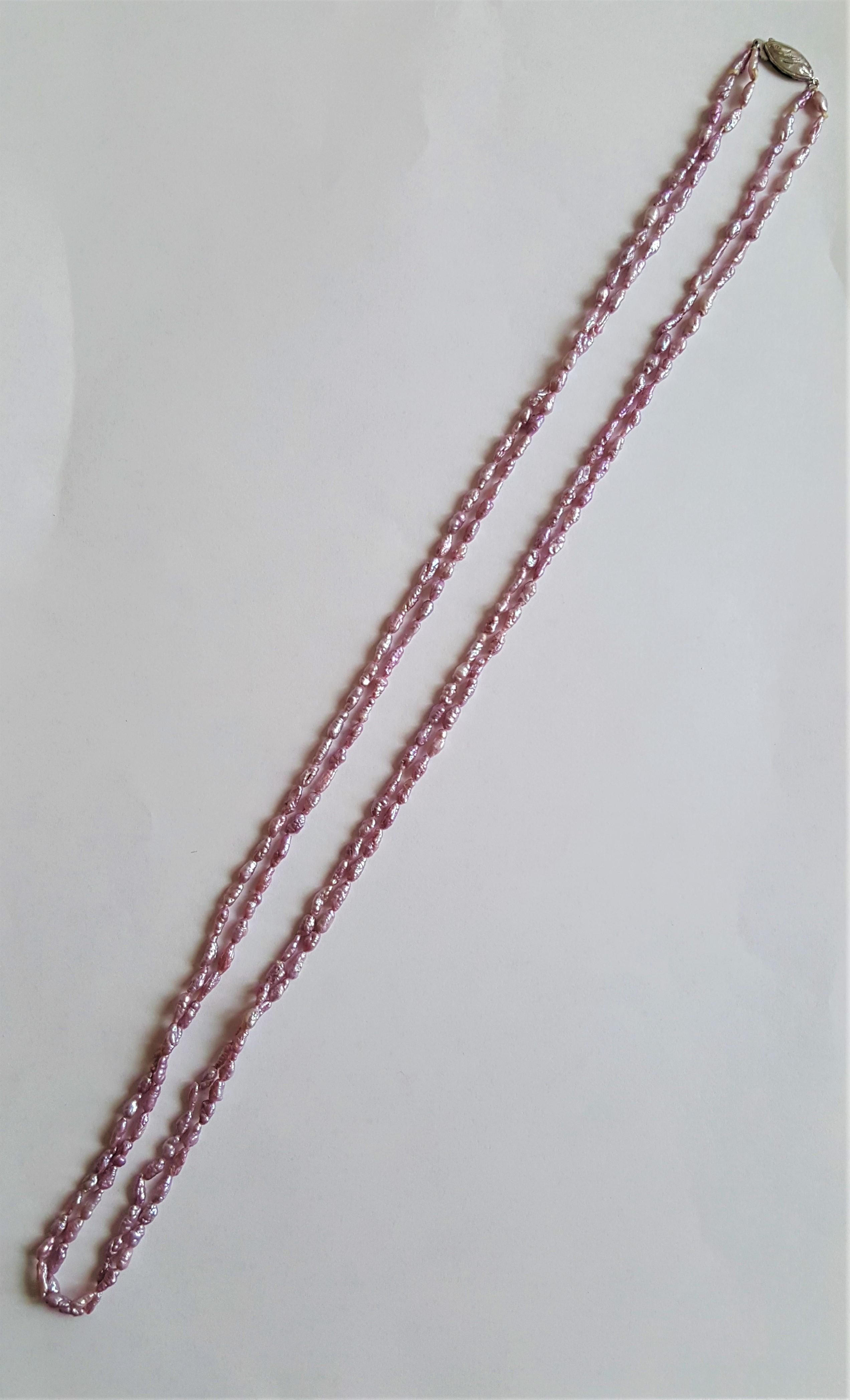 A beautiful double strand of purple lavender freshwater pearls of 28 inches secured with a silver clasp.
These pearls make a beautiful double strand and classic and timeless addition to any jewelry collection.
Please let us know if you have any