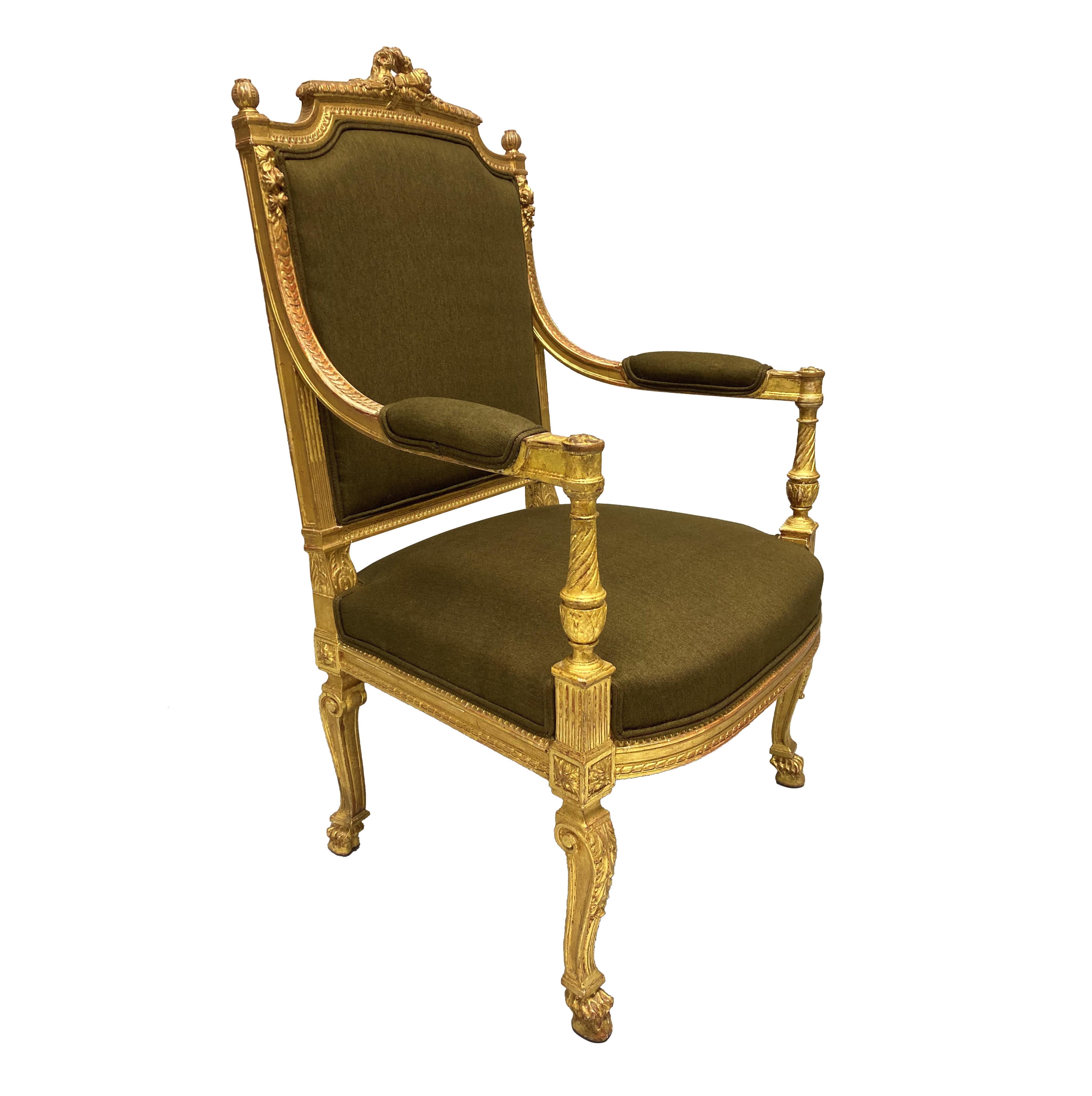 A finely carved Louis XIV style, water gilded armchair. Newly upholstered in a green/brown fabric.