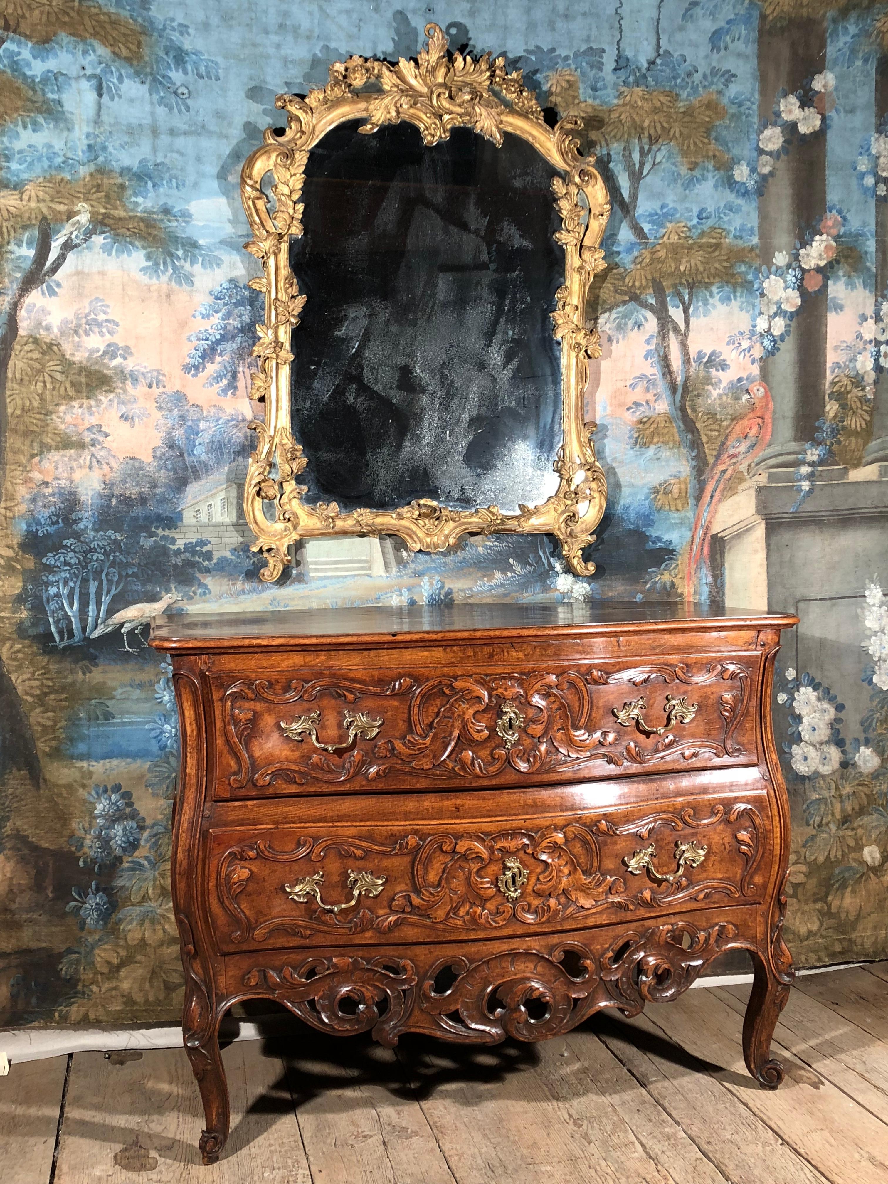 A fine quality Louis XV period giltwood frame mirror from the private collection of Pierre Moulin, founder of the Pierre Deux shops and author of Pierre Deux’s French Country.
The mirror frame has carved vines, leaves and flowers and it retains its