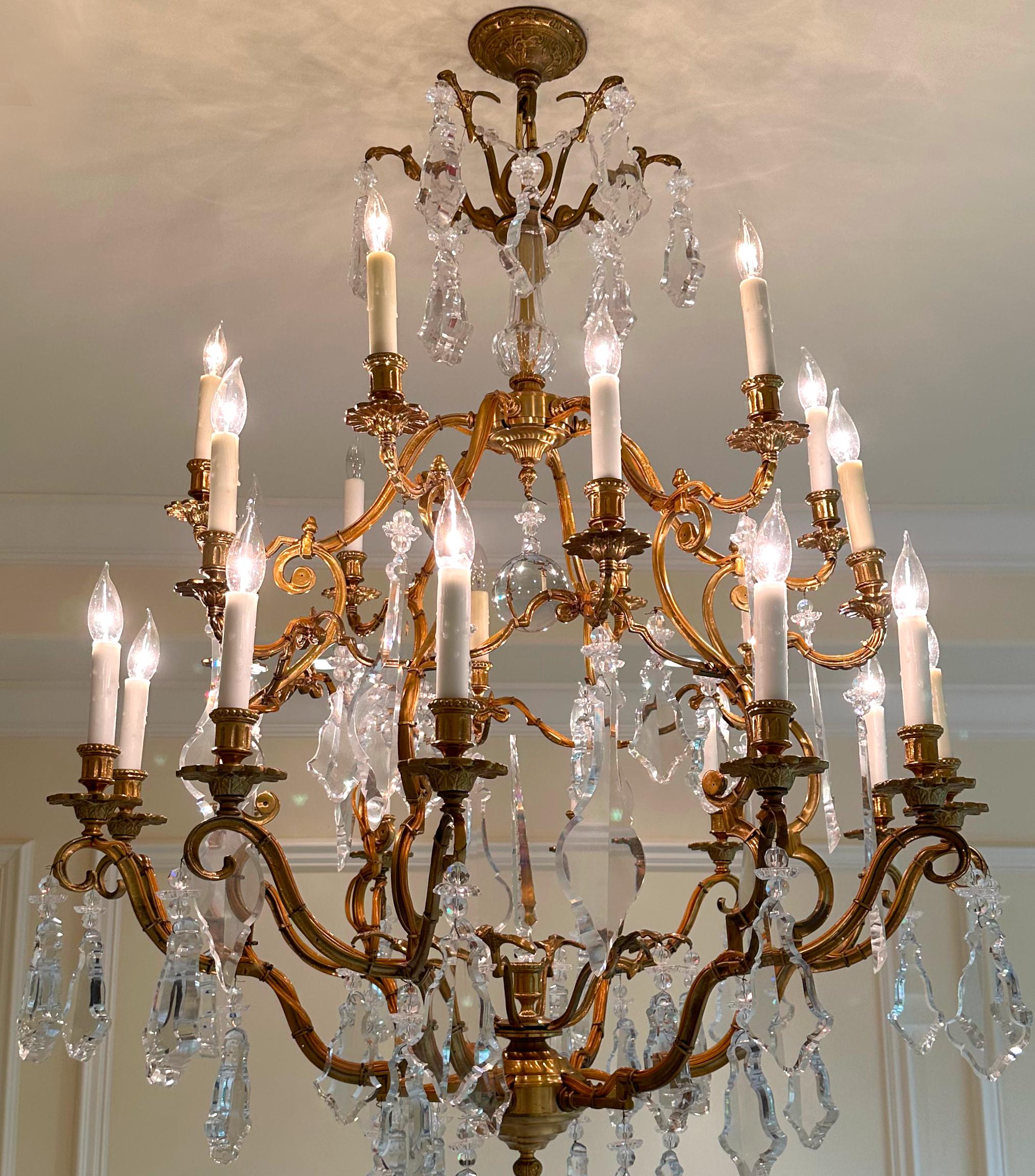 
Fine Louis XV Style Gilt Bronze & Cut-Glass Twenty-One Light Chandelier 
The cage-form corona with scrolled arms supporting nozzles and circular drip pans, the whole hung with cut glass and rock crystal prisms and chains. 
Height 56 in. (142.5