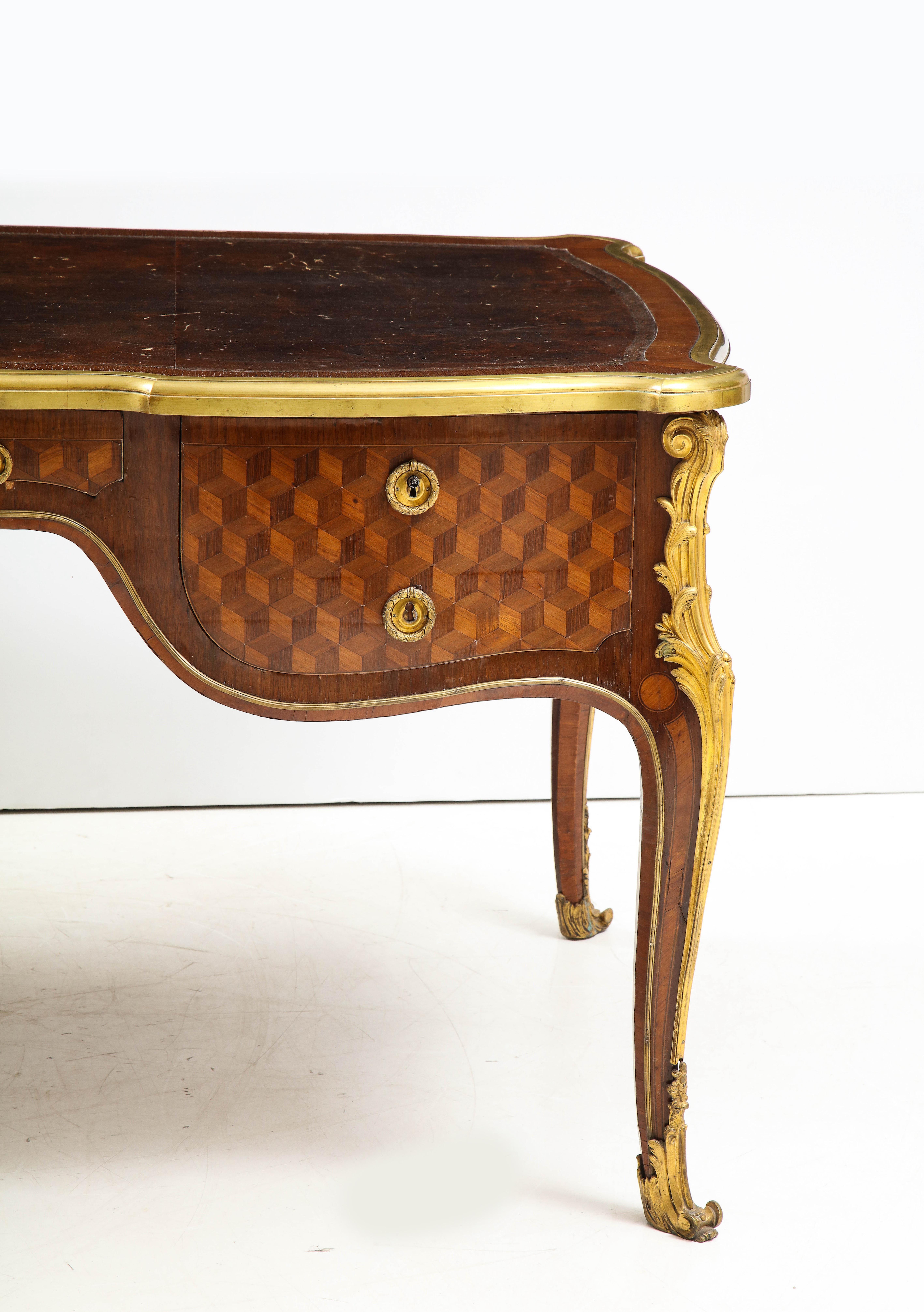 A fine and Important Louis XV style Bureau plat attributed to François Linke (1855-1946) after a model by Jean François Oeben. Typical of the work by François Linke, this desk features the finest marquetry on oak frame, showing a geometric tromp