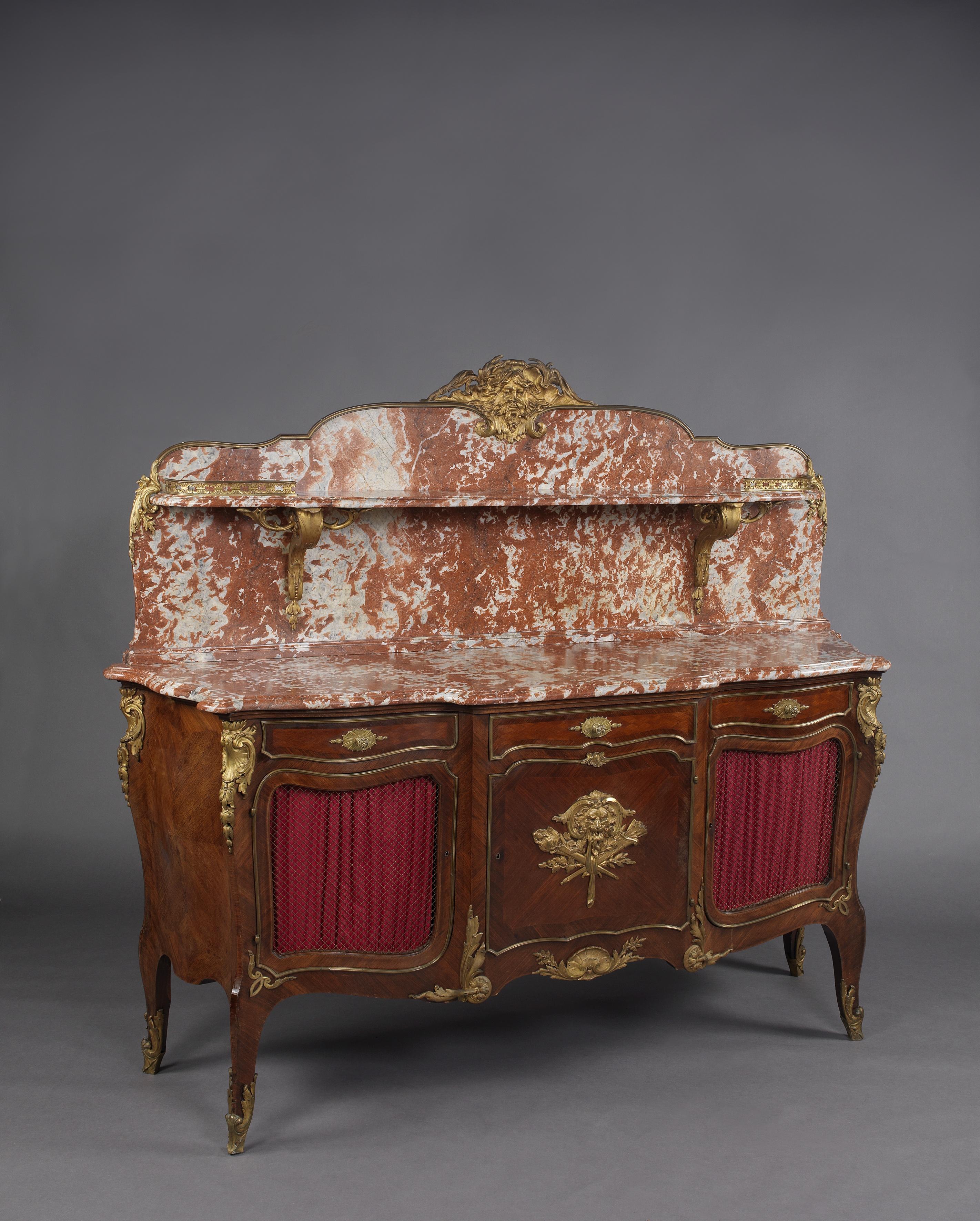 A fine Louis XVI style gilt-bronze mounted buffet a gradin, with a Rouge des Flandres marble-top and back panel. 

French, circa 1890. 

The bronze mounts stamped to the reverse 'ROGIE'. 

This imposing buffet has a Rouge des Flandres marble