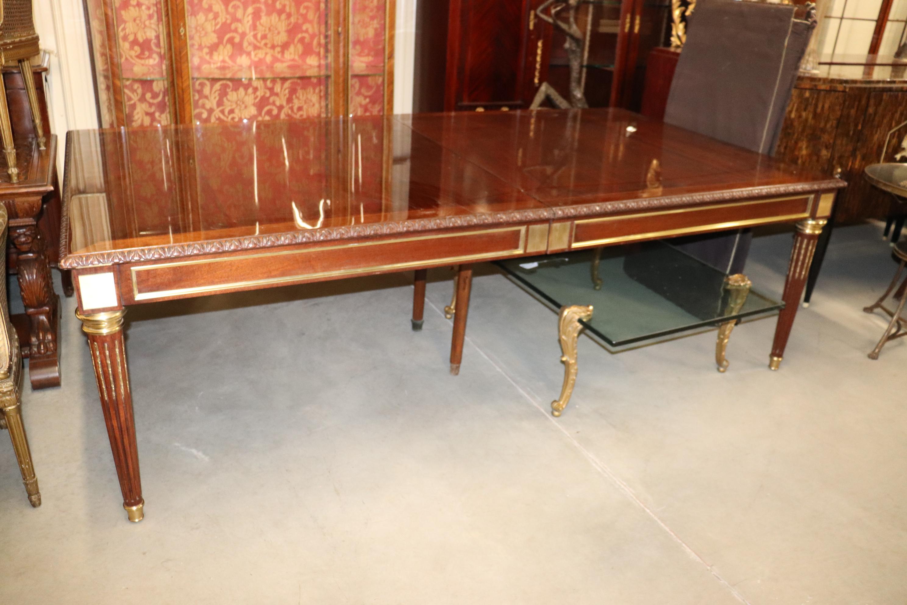 This is a fine quality solid mahogany and polished bronze carved dining table in the Louis XV style. The table is in very good condition but will have fine scuffs and scratches on top from use but nothing obtrusive or very noticeable. You'll be