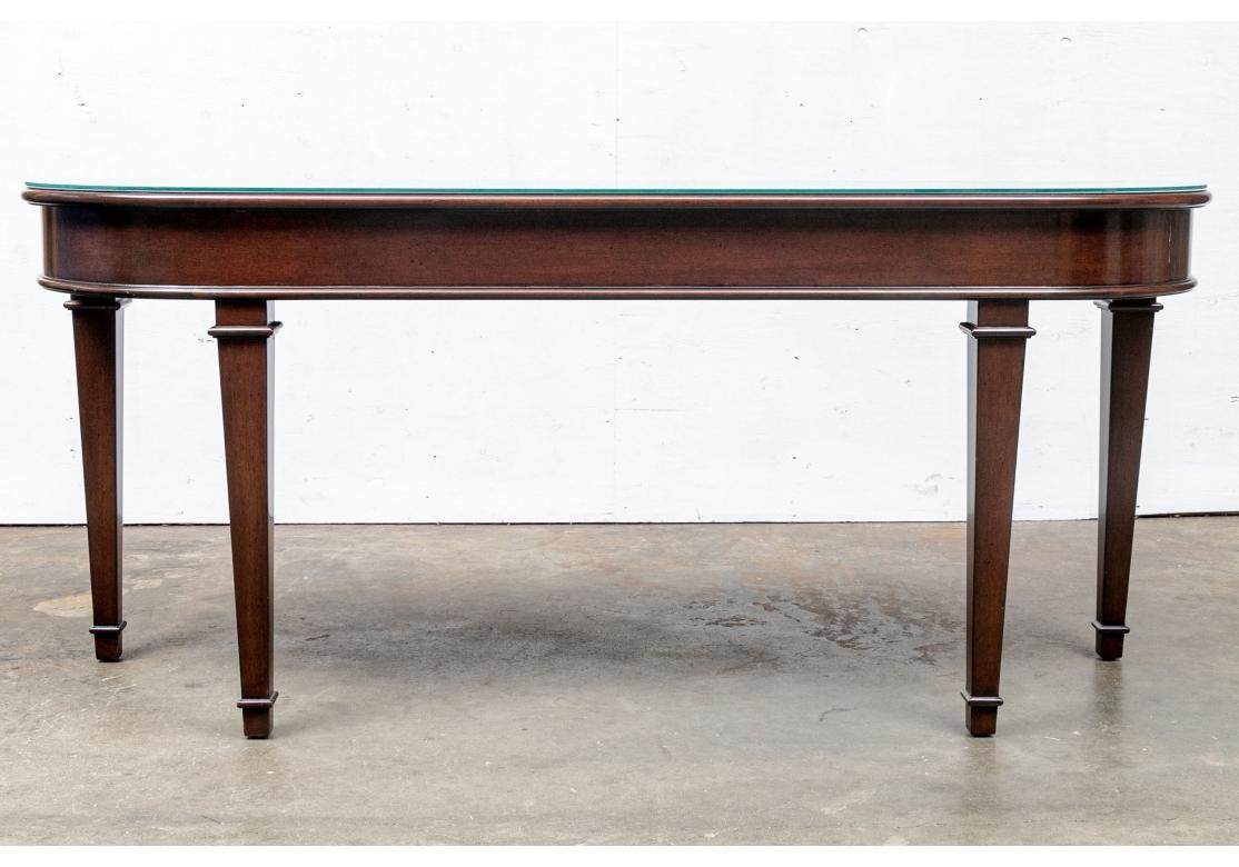 A very well made Console Table with bold and solid form A classic console table with conforming glass top, 6