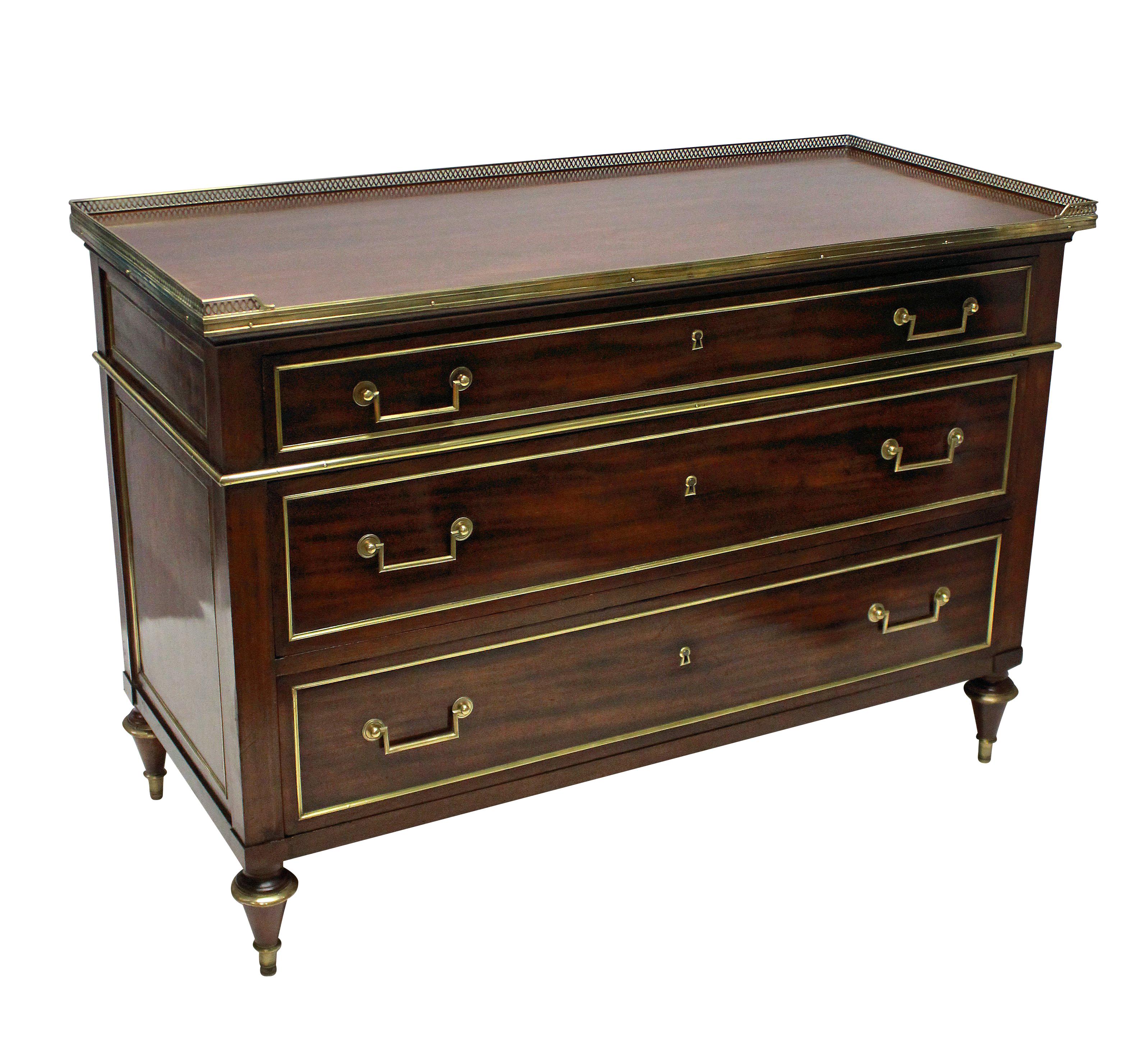 A fine French mahogany Directoire commode, oak lined and with brass detailing and pierced galleried top.