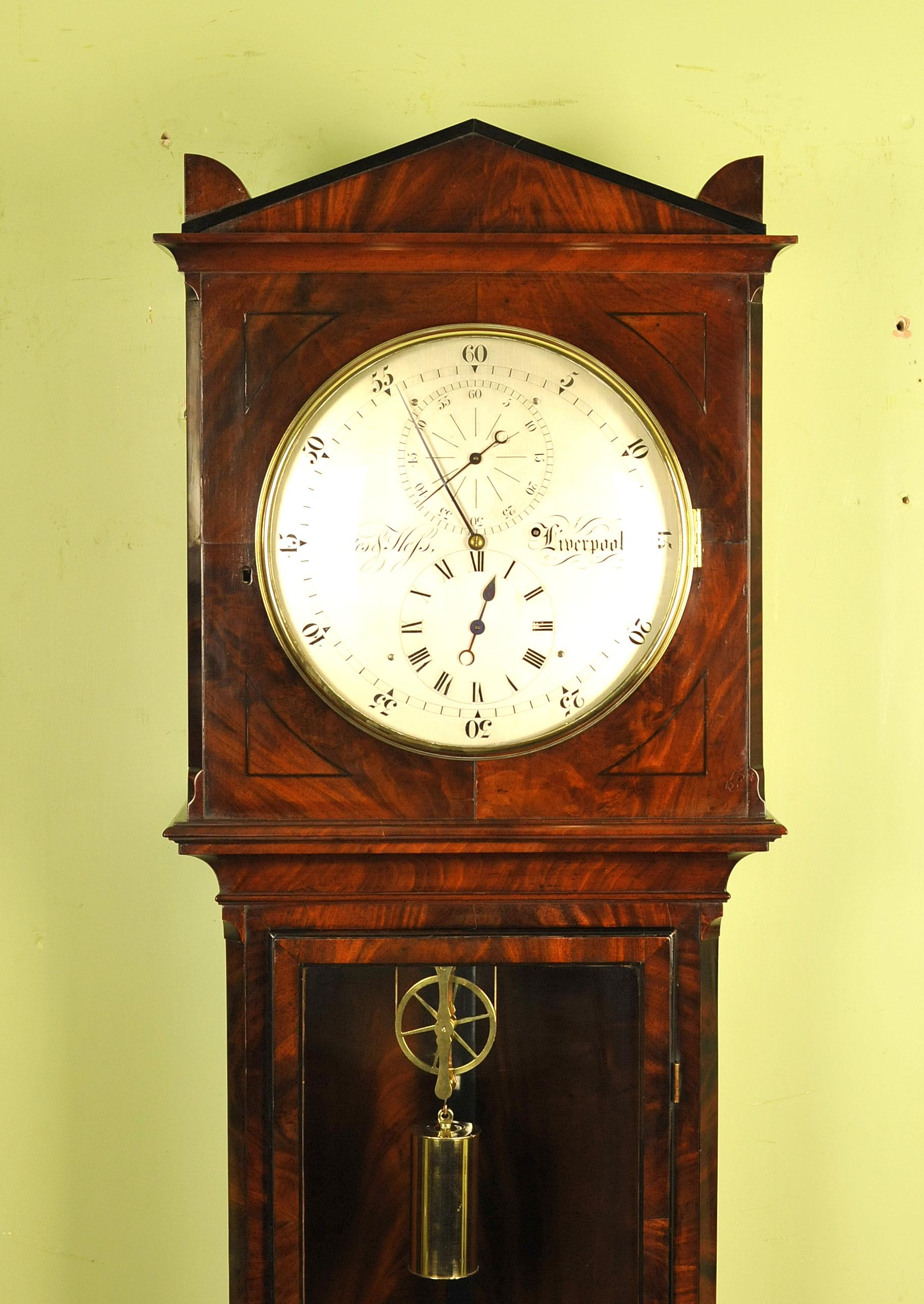 This is a very nice English precision floor standing regulator of small size being only 7 feet tall at its maximum with the centre of the dial measuring 5 ft 7 inches from the floor.
The 12 inch engraved silvered dial of regulator layout bears the