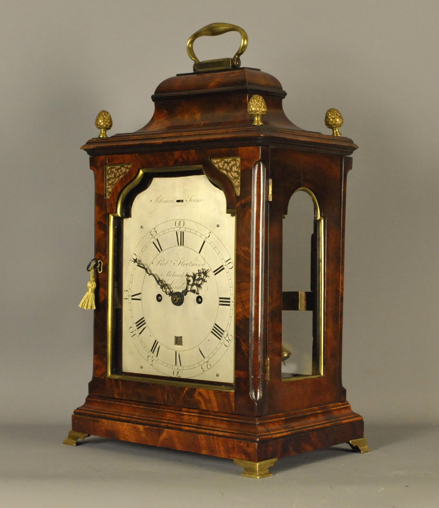This is a very fine and elegant flame mahogany verge bracket clock by Robert Fleetwood who worked in Abchurch Lane from 1763 and died, circa 1794. This clock would date around 1780.
The inverted bell top case is surmounted by a brass carrying