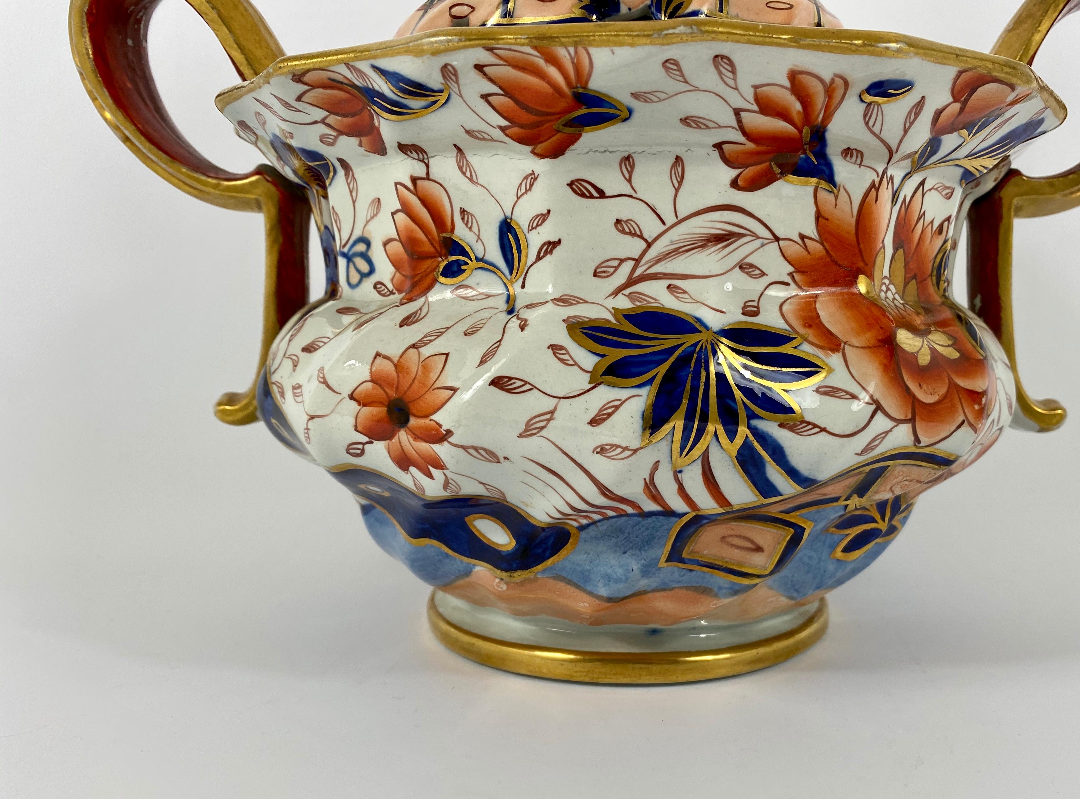 A large and exceptional quality Masons Ironstone pot pourri, circa 1820. The moulded body, finely painted in a Japan pattern of flowering plants in a garden, heightened with gilding. Having twin gilded strap handles.
The pot pourri retains its