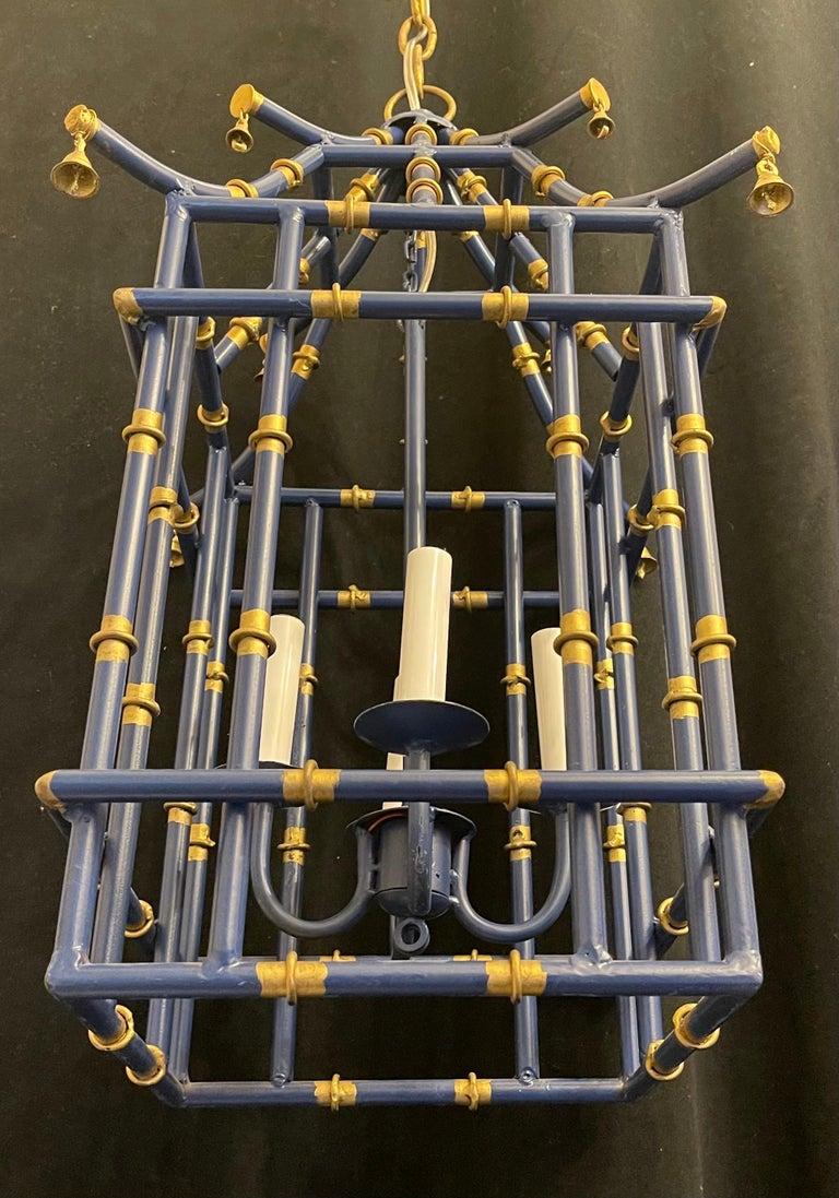 A wonderful medium sized navy blue & gold gilt pagoda bamboo form chinoiserie lantern fixture with 4 candelabra light cluster.
Rewired and ready to install with chain canopy and mounting hardware.

 