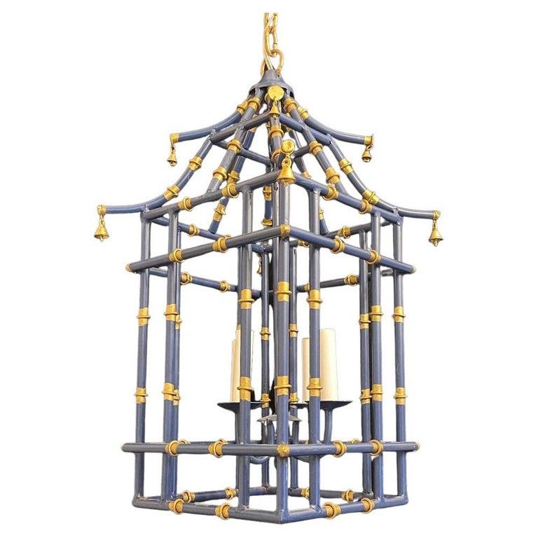 A wonderful pair medium sized navy blue & gold gilt pagoda bamboo form chinoiserie lantern fixtures with a 4 candelabra light clusters
Rewired and ready to install with chain canopy and mounting hardware.

* Each Lantern Separately, Two Available.