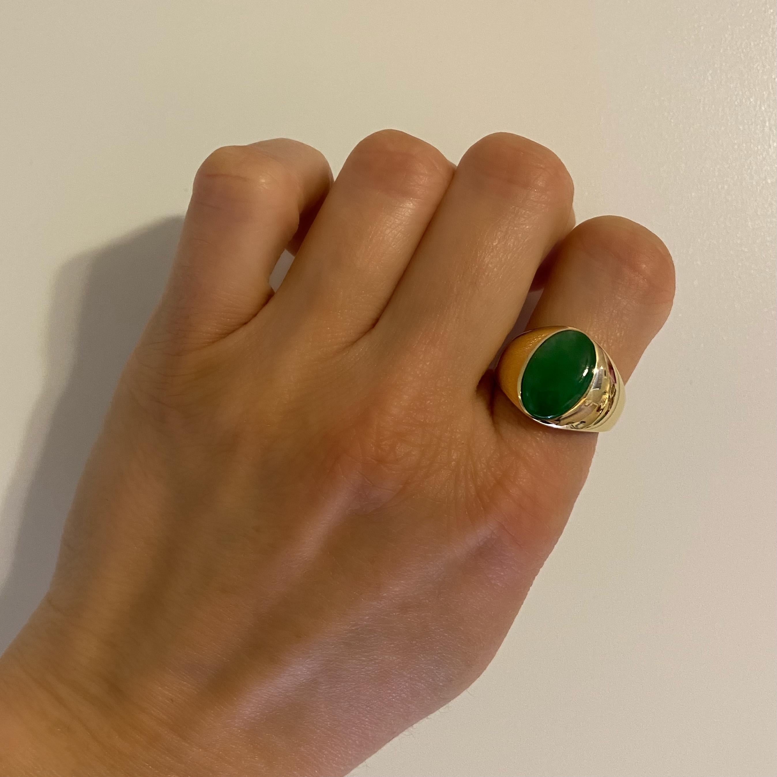Handsome High Quality Men’s Gold Ring, securely set with a Cabochon Oval Jadeite Jade, hand crafted in 18 Karat Yellow Gold mounting. GIA #1216498224. Ring size 8.25, ring sizing available. Dimensions 0.89”w x 0.63”h x 1.05”d. In excellent