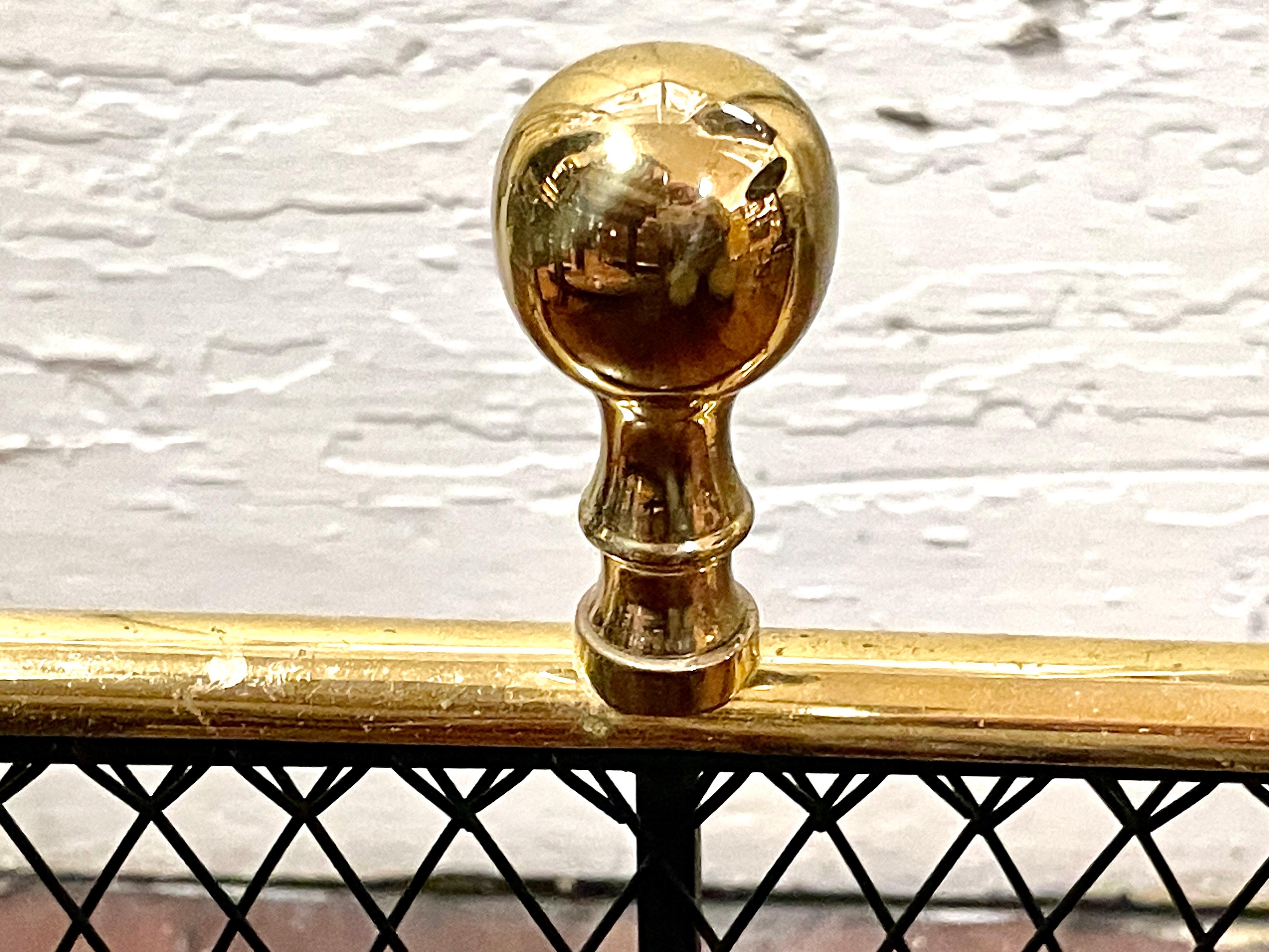 A Very Fine Old Reproduction heavy Cast Brass and fine hand woven wirework Serpentine Shape Fireplace Fender or Nursery Guard.  Please note the handsome cast brass lion's paw feet and heavy cast brass ball top finials.  The wirework is intricately