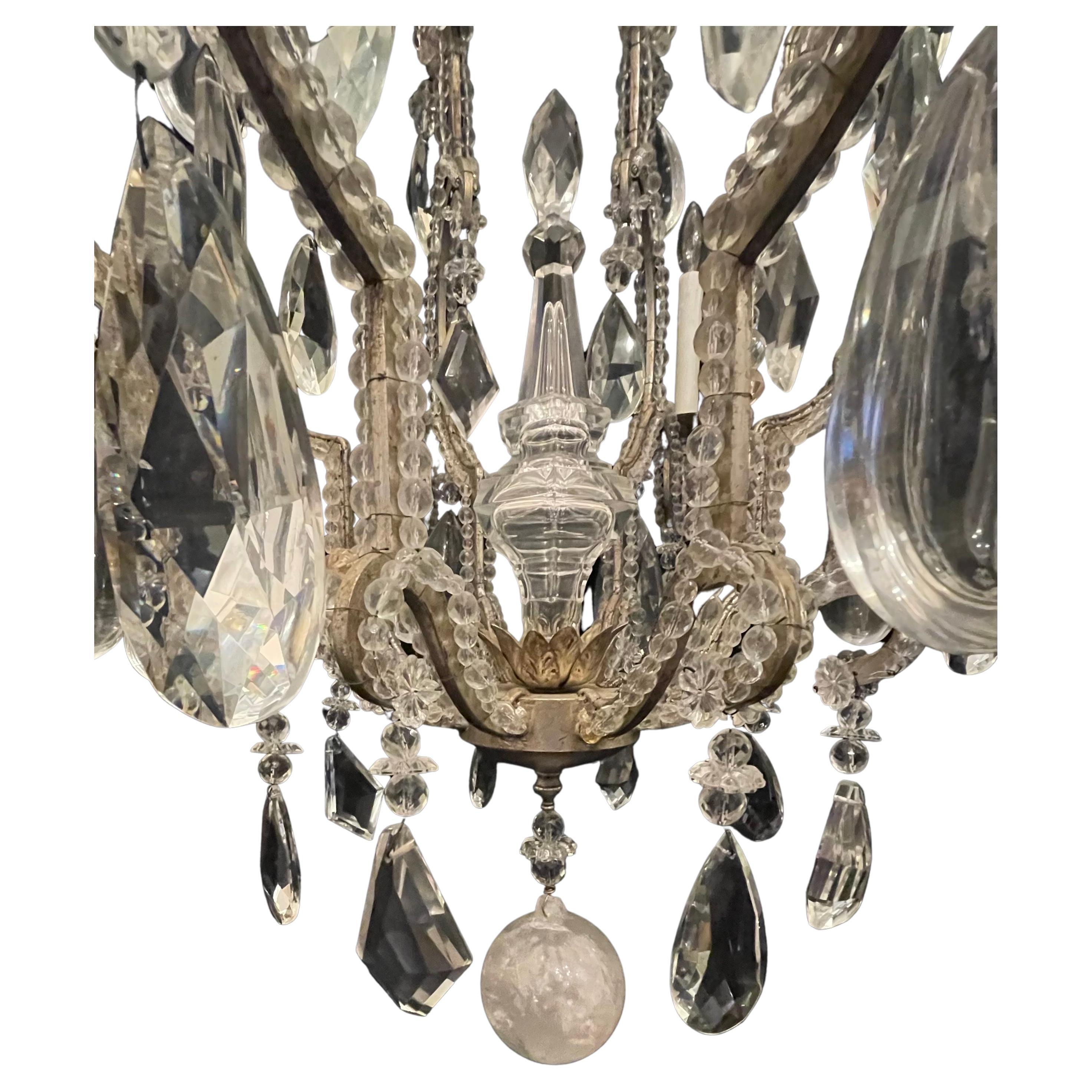 A Wonderful Mid-Century Modern Maison Baguès Style silver gilt with beaded french bird cage form body having alternating rock crystal and multi dimensional crystals through out, this large chandelier has 8 candelabra lights surrounding the outside