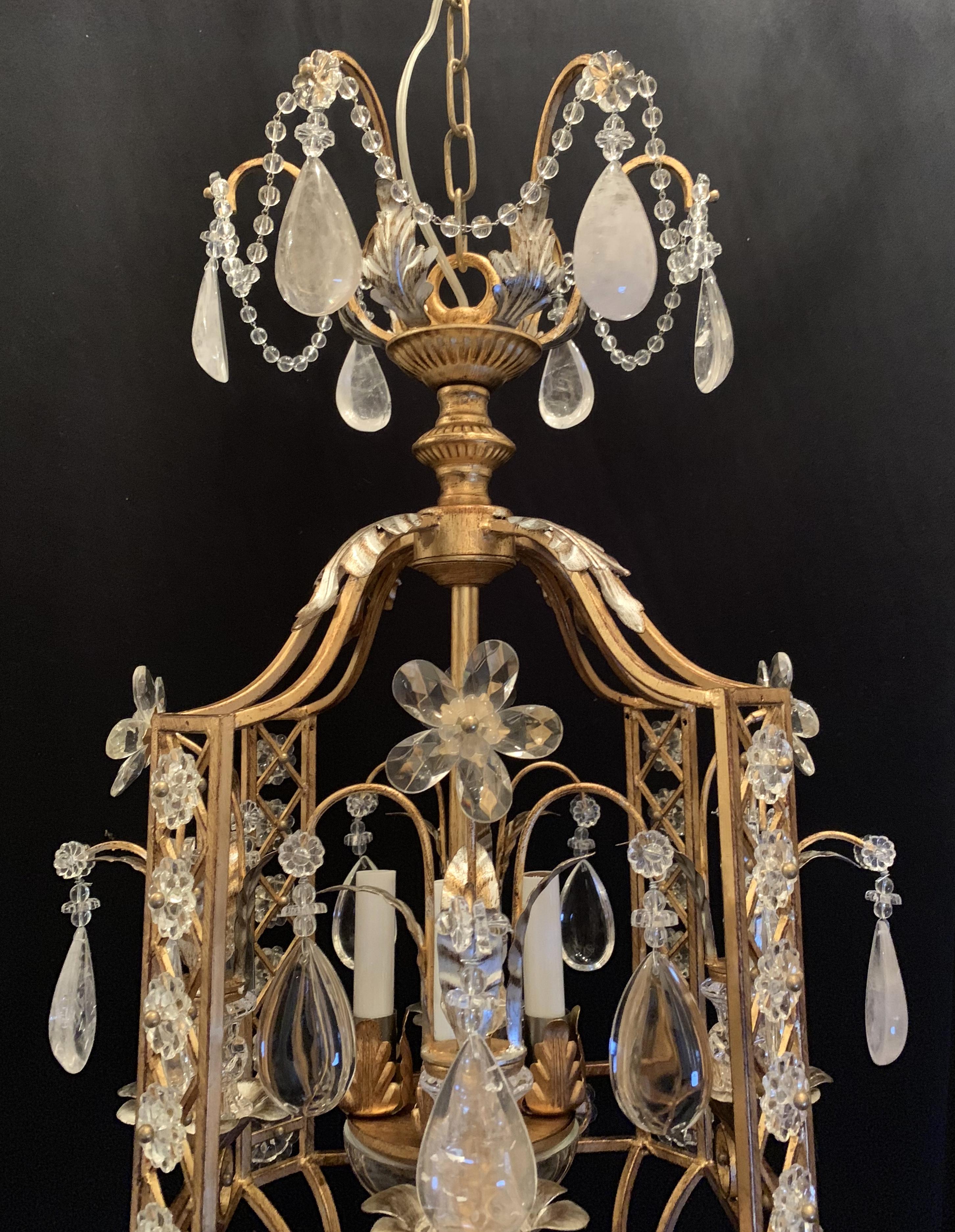 A fine Mid-Century Modern french baguès style rock crystal 4 candelabra light lantern pagoda form silver and gold gilt mix set of 3 chandeliers with beaded swags.
Each sold separately.