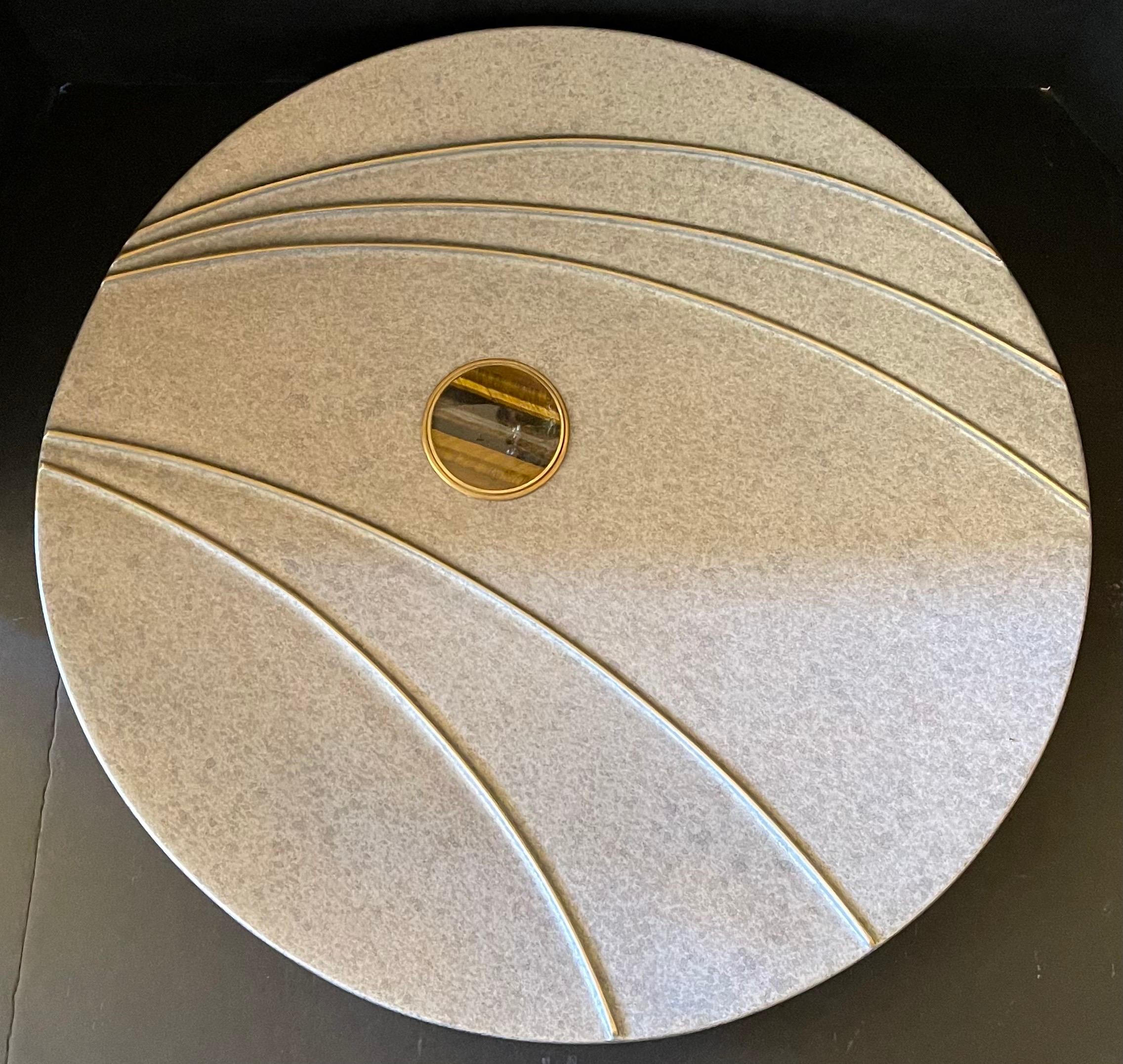 A wonderful Mid-Century Modern Lorin Marsh large round centerpiece inset with a precious tiger eye stone and a brass band in a metal silver flake finish

Measures: 21