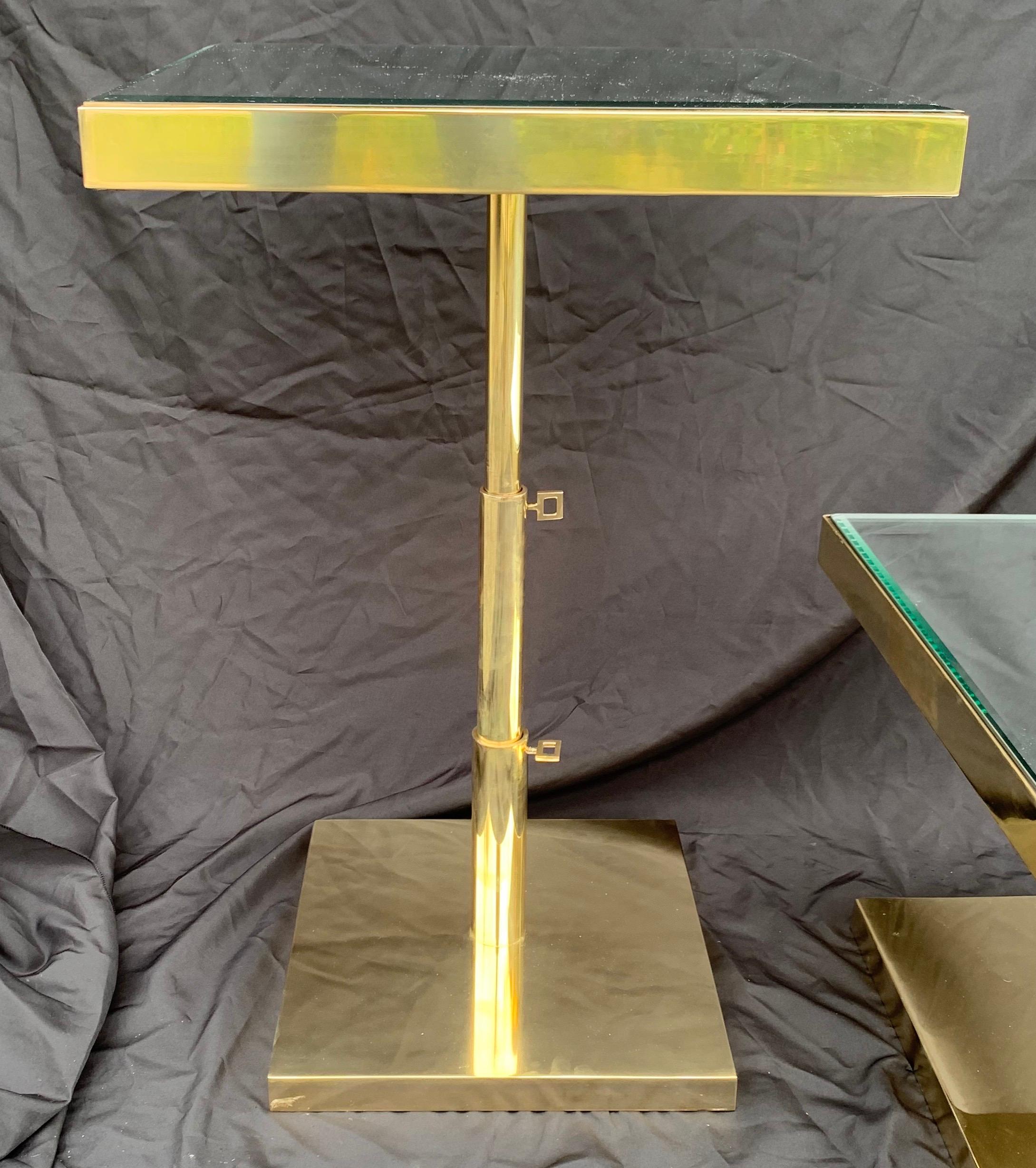 A wonderful  Mid-Century Modern polished bronze and beveled mirror top, telescoping square side tables height is adjustable by 2 knobs.
31