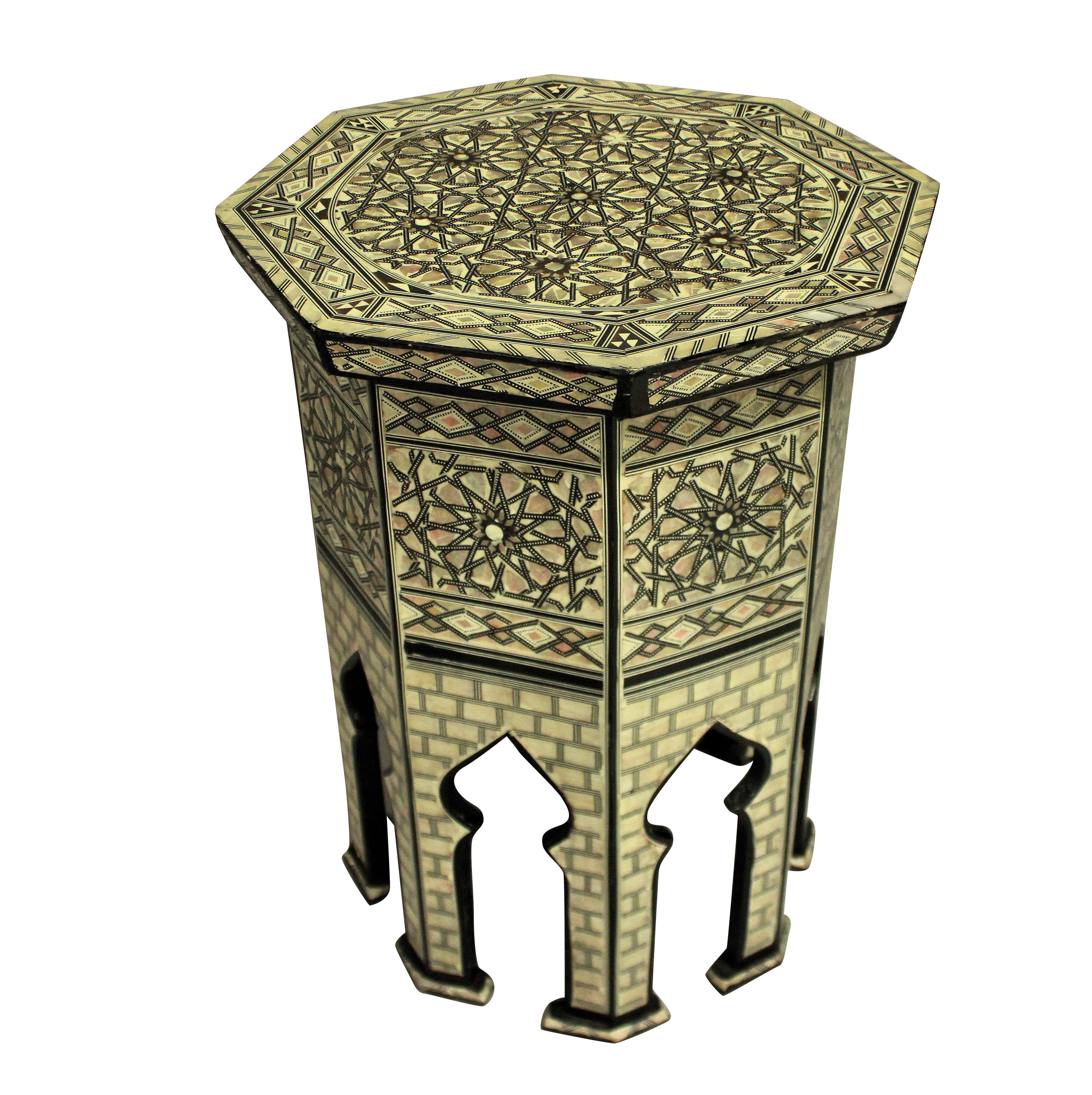 A fine Middle Eastern side table inlaid with ebonized hardwood, bone and mother of pearl in geometric designs.
