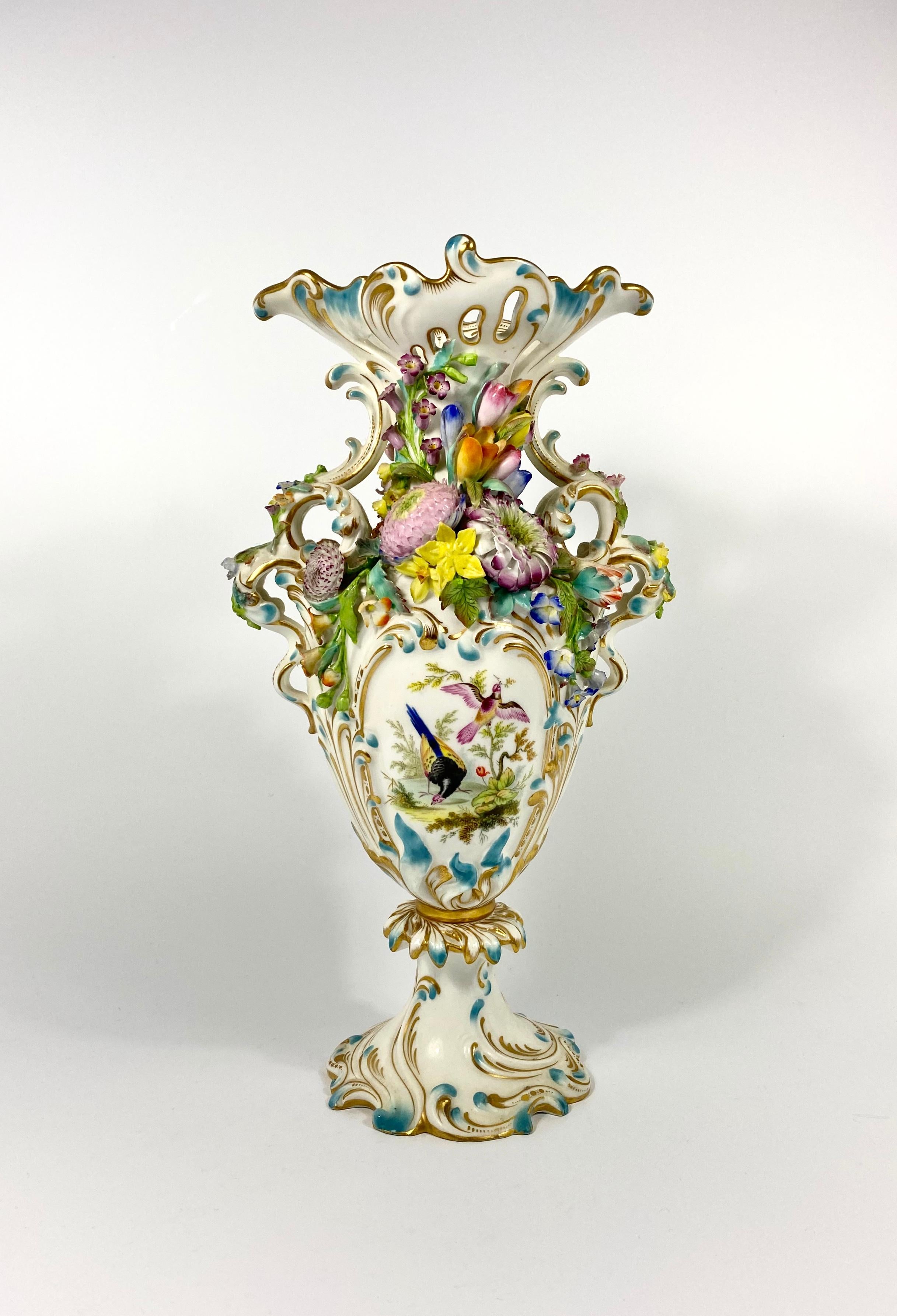 An exceptionally fine Minton porcelain garniture, circa 1830. Each rococo style vase, painted with exotic birds, within elaborate scroll borders, the reverse painted with buildings and figures above rivers, in rural settings.
The necks encrusted