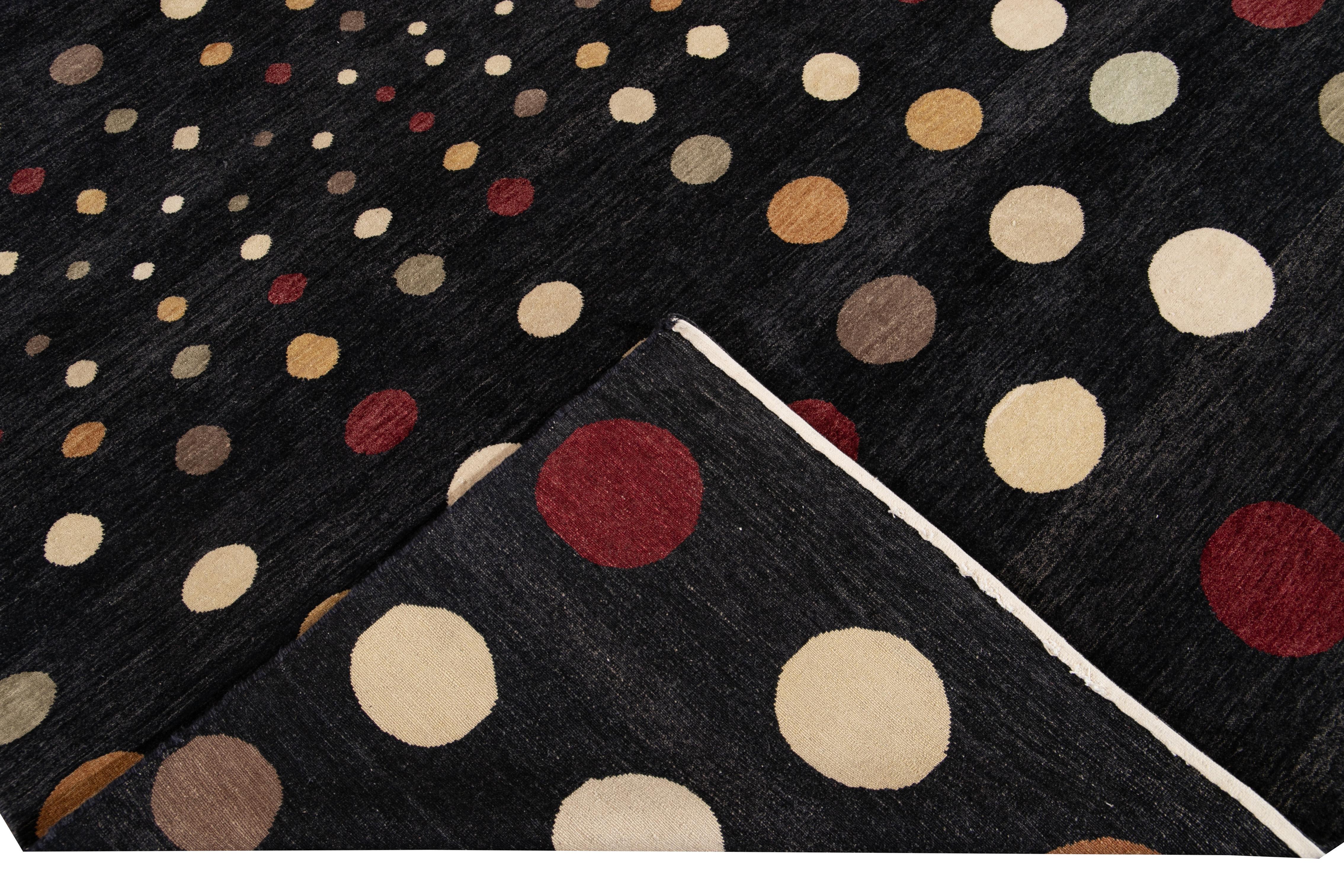 Beautiful 21st century contemporary hand knotted wool rug with a black field. This modern rug has multi-color accents in an all-over polka dot design.

This rug measures: 6'2