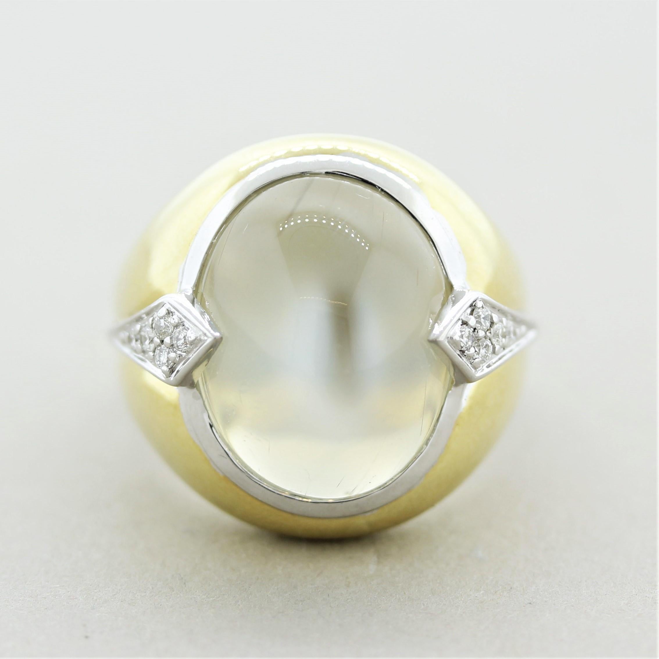 A large and impressive moonstone ring! The moonstone weighs 13.74 carats and is of excellent quality. Bright bluish-white flashes can be seen across the stone known as adularescence (a special phenomenon of fine quality moonstones). It is accented