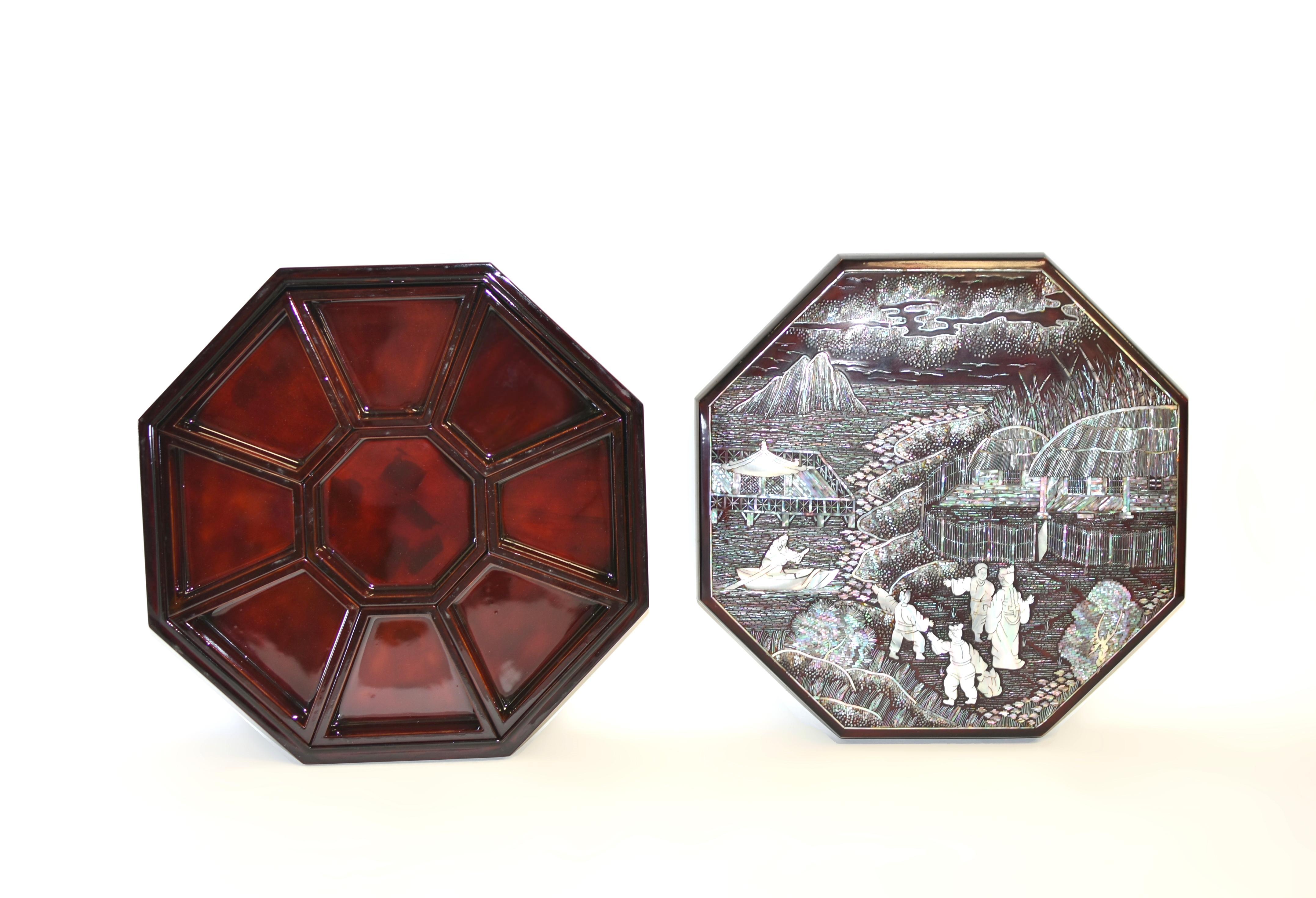 From a private collection, this extraordinary mother of pearl box is a splendid creation, meticulously hand-crafted to depict a serene scene of riverside life. In the foreground, a family enjoys leisure time in front of two large houses with