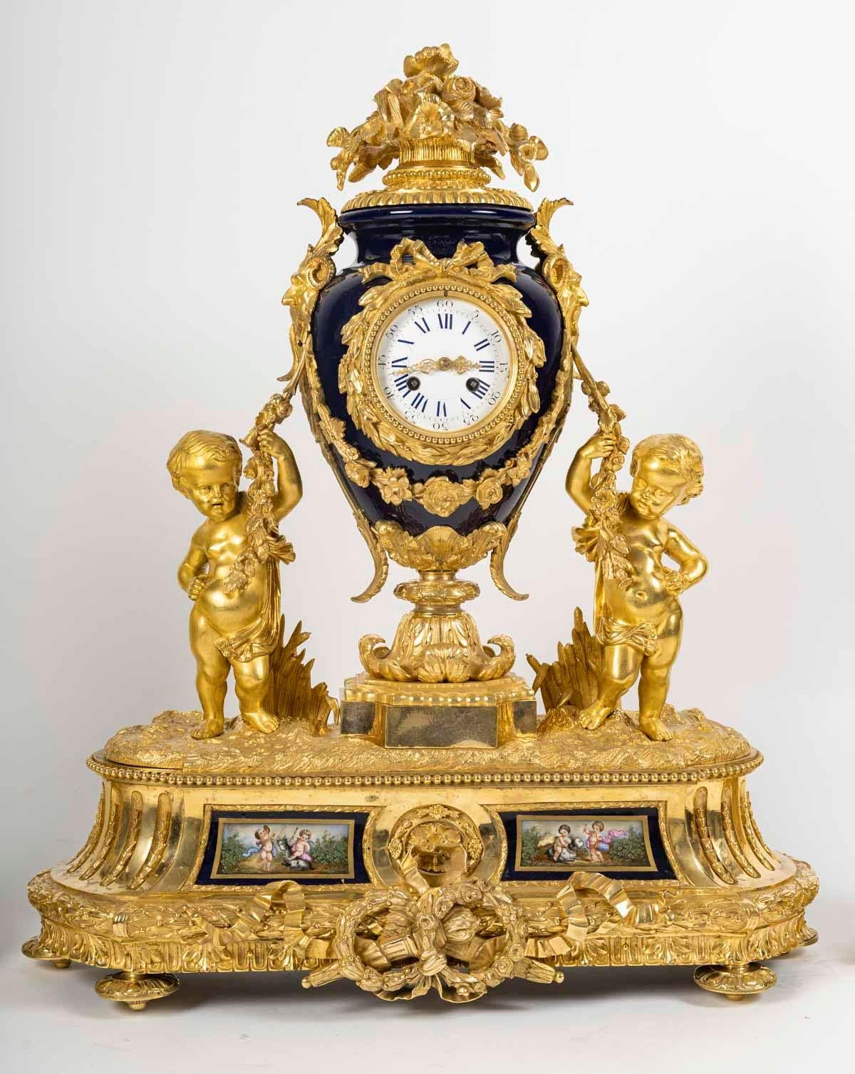 Fine Napoleon III period mantel set, 19th century.

Gilded bronze and Sèvres porcelain mantelpiece from the 19th century, Napoleon III period.
Clock: H: 70cm, W: 62cm, D: 20cm
Covered vases: H: 59cm, W: 22cm, D: 16cm