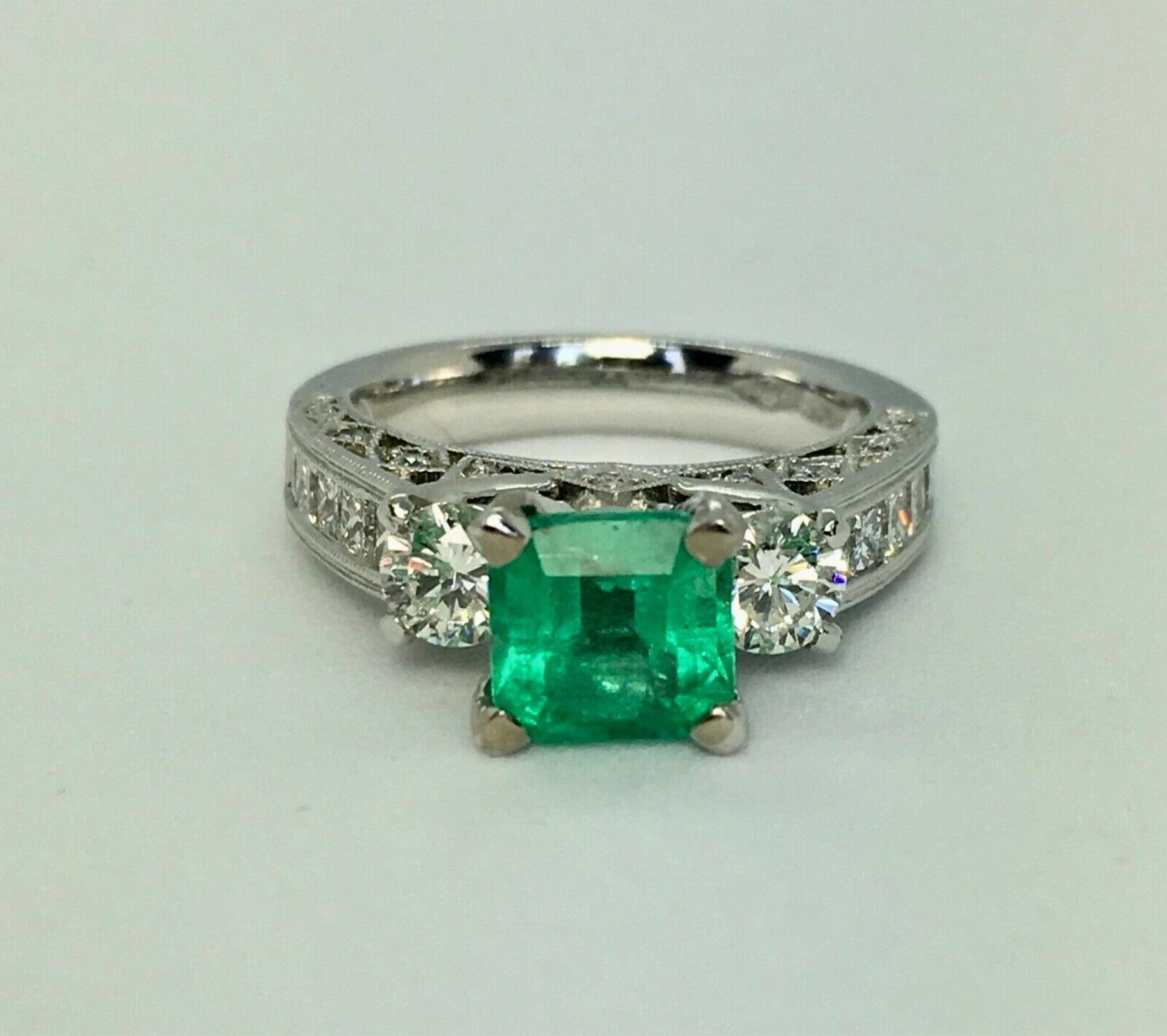 Fine Estate Natural Colombian Emerald Diamond Engagement Ring
Centered with a stunning natural Colombian Emerald 1.10 carat Vivid Medium Green, excellent brilliance and saturation.
Side natural Diamonds totaling 1.80 Carats, Clarity  VS1/ Color