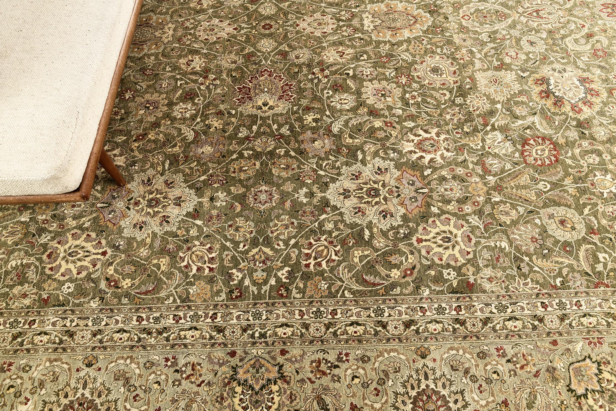 An exceptional revival of Hadji Jalili Natural Dye Tabriz rug that immensely encompasses the beautiful blooming scrolls and traditional Persian designs in a forest green field that keeps  the pattern very distinctive. This rug is suitable for both