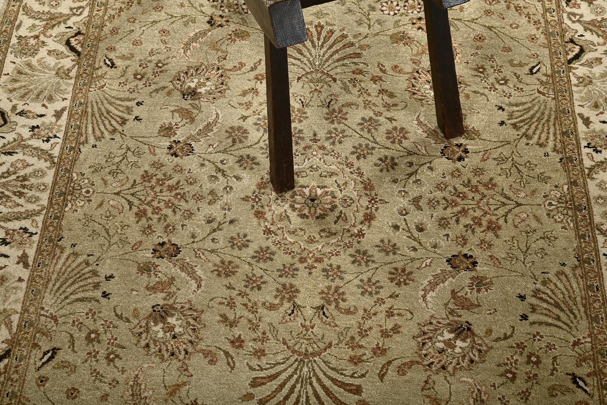 An elegant revival of Tabriz Hadji Jalili rug that gracefully establishes sophistication through the all over botanical petterns of the blooming palmettes, serrated leaves, leafy tendrils and feather-like motifs. Flanked by inner and outer floral