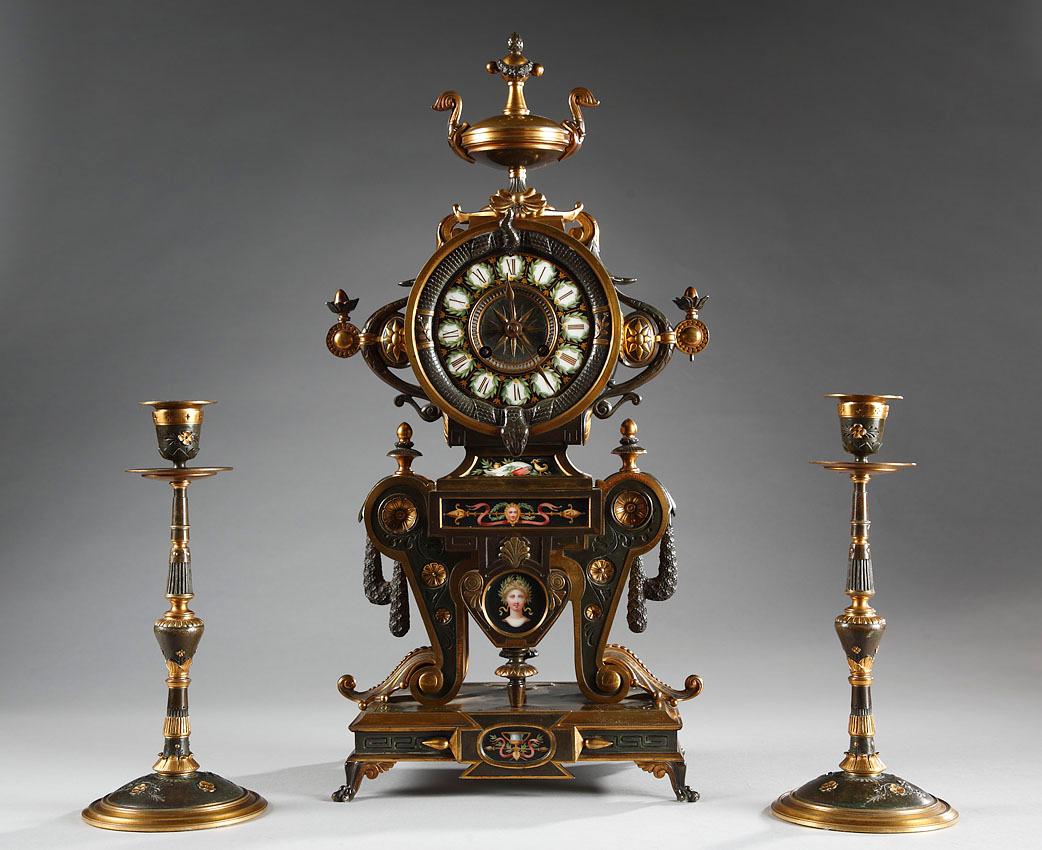 Dial signed H. Houdebine, Fabricant de Bronzes, Rue de Turenne 64, Paris
and clockwork signed Japy Frères & Cie – Médaille d’Honneur

A very fine neo-Greek style clock set made up of a clock and a pair of candlesticks. The clock executed in two