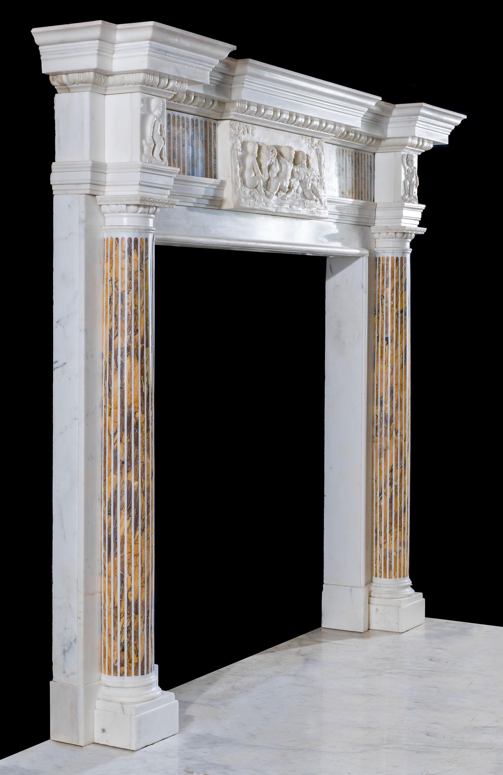 A fine and grand neoclassical chimneypiece in statuary marble with Siena marble inlay. The boldly carved breakfront shelf sits above a high relief egg and dart undershelf and a finely fluted frieze inlaid with Siena marble. This is mounted with a