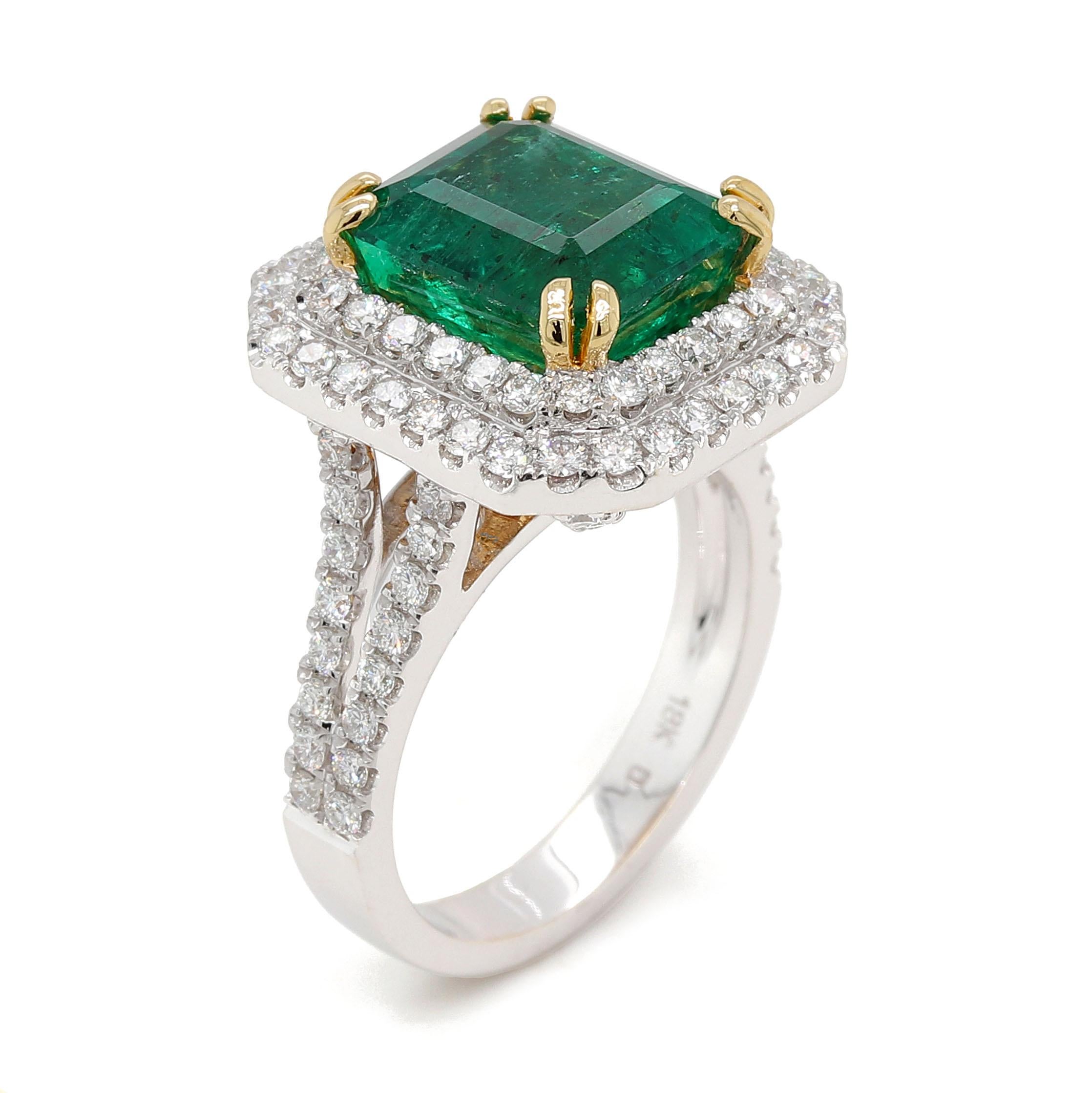 Ring with a fine octagonal cut Emerald of about 4.76 carats measuring 10.16×8.901×6.95mm. The Origin of the Emerald is Zambia. The Emerald is surrounded by 106 round brilliant cut diamonds of about 1.29 carats with a clarity of VS and color G. All