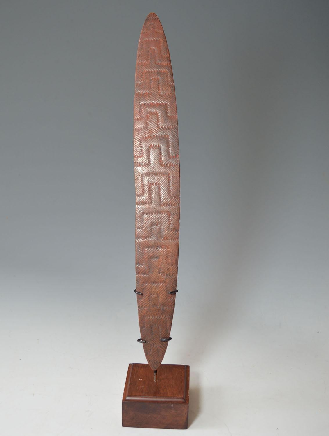A fine aboriginal churinga with stone carved layered interlocking design to one face.
The churinga is a sacred message board for the Australian aboriginal people
and holds religious messages sacred to the tribe or individual who made it and would be