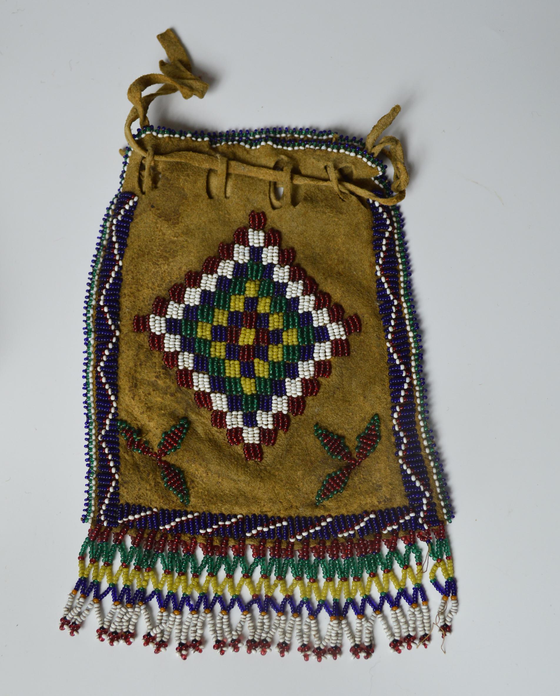 Fine old native American Indian Apache beaded bag
Buckskin, finely beaded on the both sides with glass beads in floral and geometric designs with bottom fringe
Central plains
Measures: Height 17 cm 7 inches,
Period: Late 19th century-early 20th