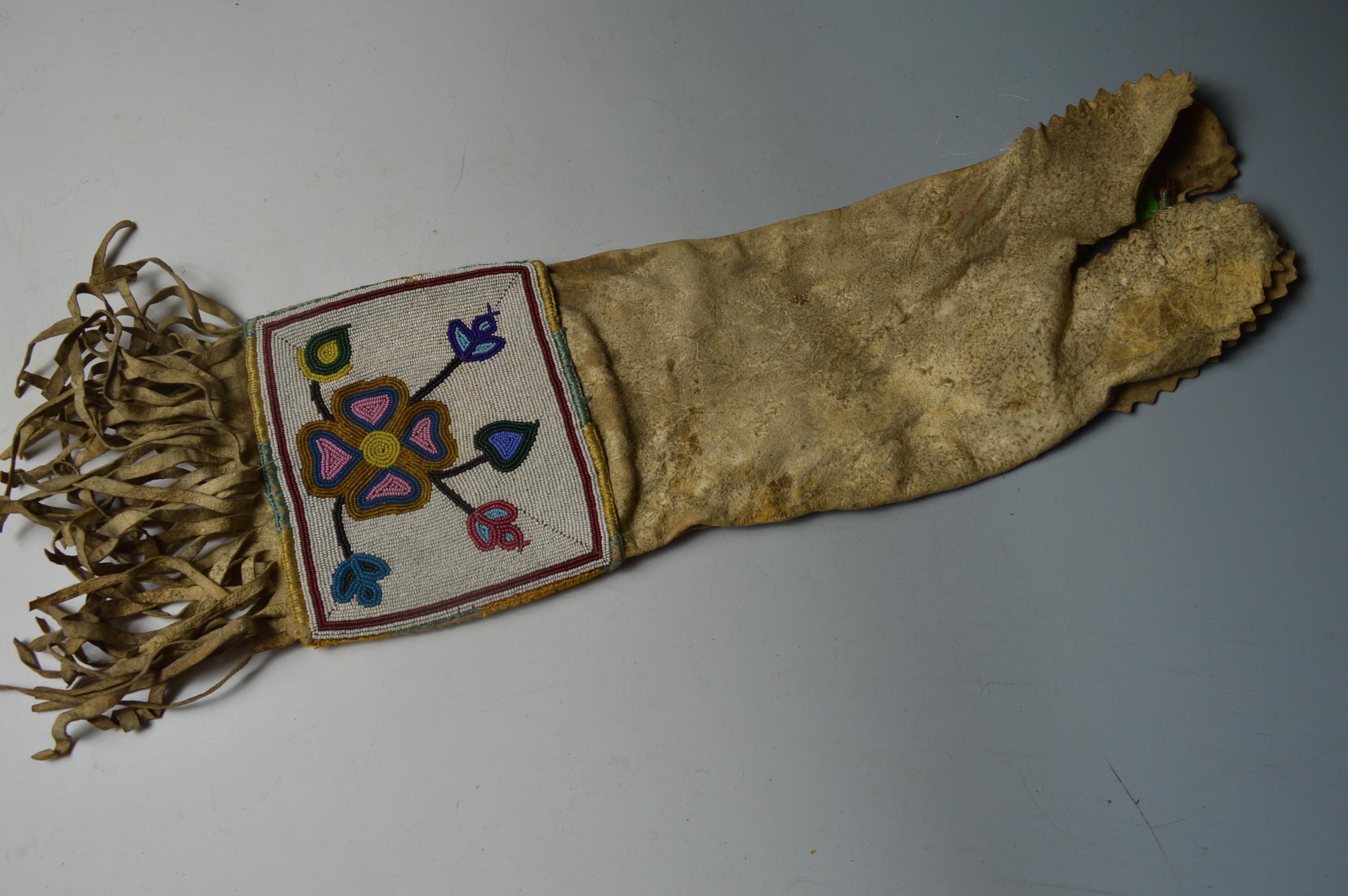 A fine Native American Ojibwe beaded pipe bag.

Buckskin finely beaded panels on the both sides with glass beads in floral designs,
with long fringe 

Period: Eastern woodlands Last quarter 19th century 

Condition: good

Provenance: Ex UK