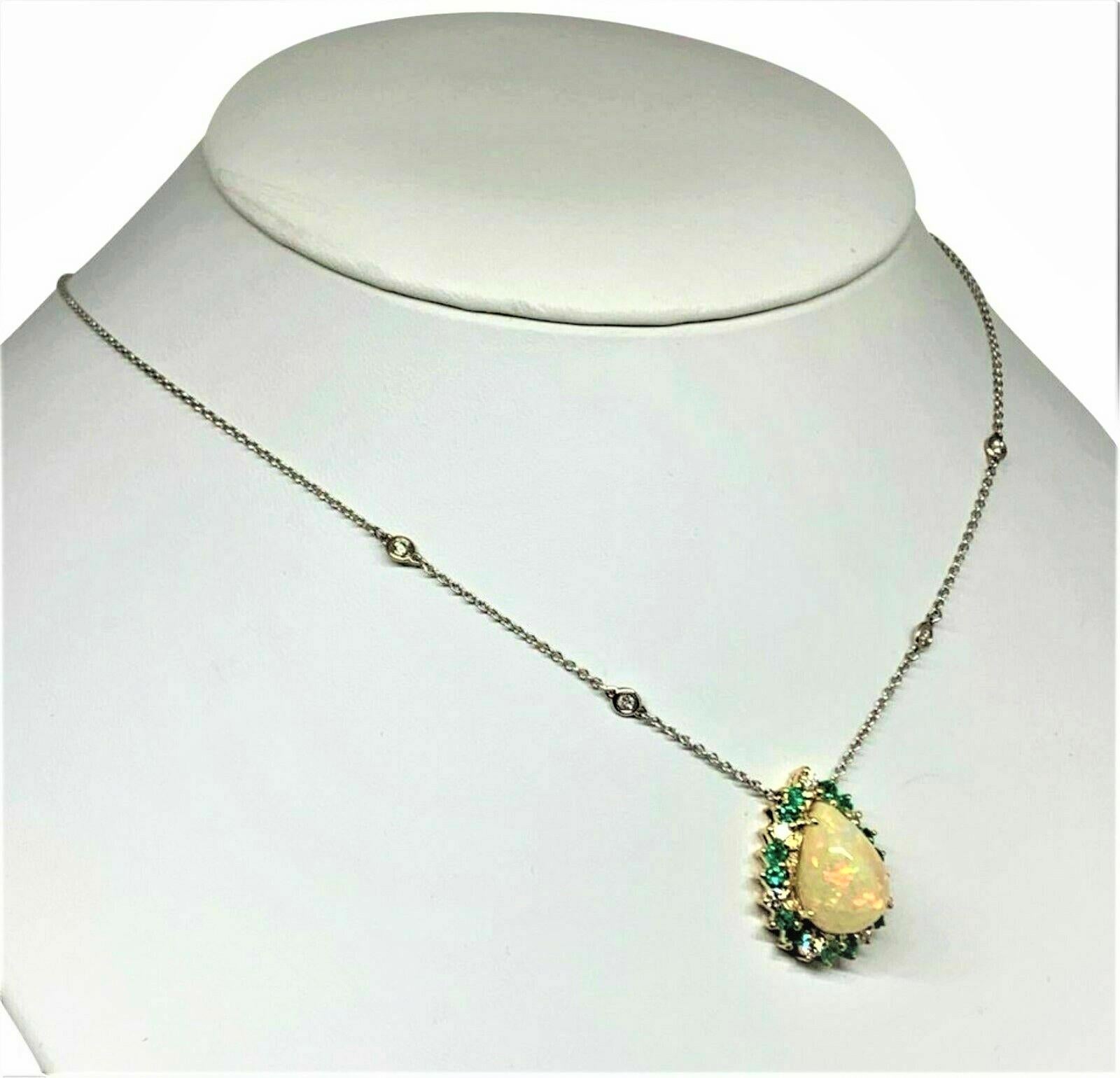 This is a very Fine Quality and Elegant Large Natural Opal surrounded by Emeralds and Diamonds LARGE 8.57 TCW hanging from a 14 KT Solid Gold Diamond Necklace
Made In Italy.

This necklace has been certified for $7,950 
This is a One of a Kind