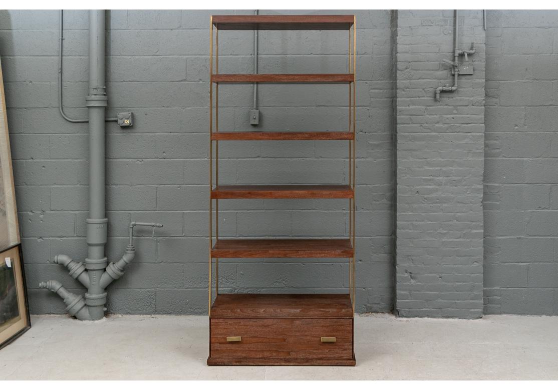 The large scale etagere with flat brass supports and six dark faux oak grain shelves. The carved base with a drawer with rectangular brass pulls. 

Dimensions: H. 87