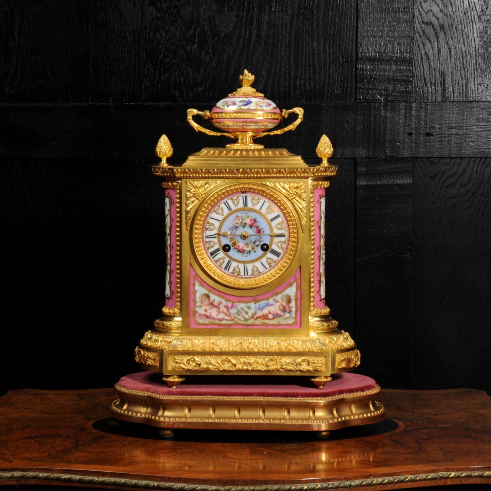 A fine ormolu (mercury fire gilded bronze doré) clock mounted with exquisite Sèvres style porcelain with Rose Pompadour pink ground. Made by the renown Parisan maker Jean-Baptiste Delettrez and retailed by Glasgow jeweller J&W Mitchell. Classical in