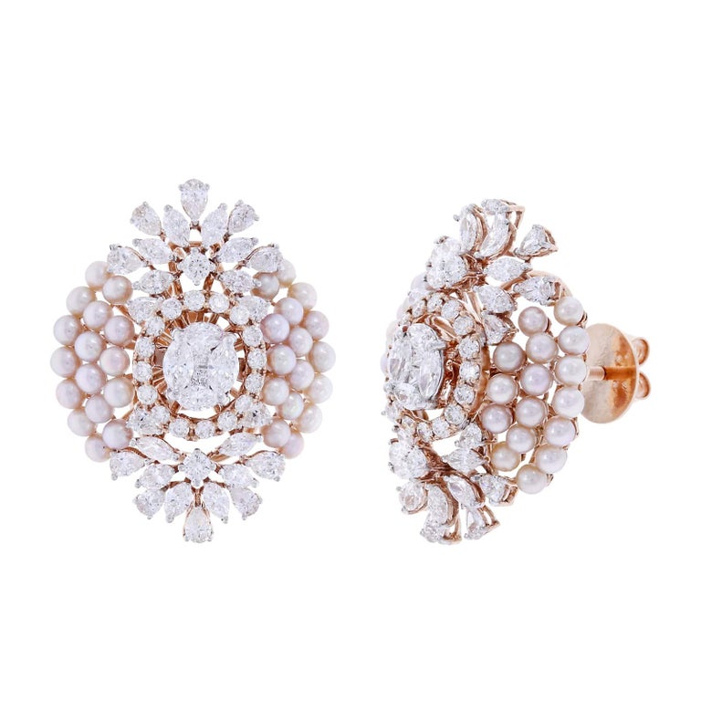 An oval shape of earrings set with pearls and diamonds. The diamonds are have a mix of princess, marquise, pears, and round cut diamonds weighing appx. 5.12 cts. total. Estimated Color: H, Clarity: VS. The pearls are appx. 11 cts. Set in 18K Gold.