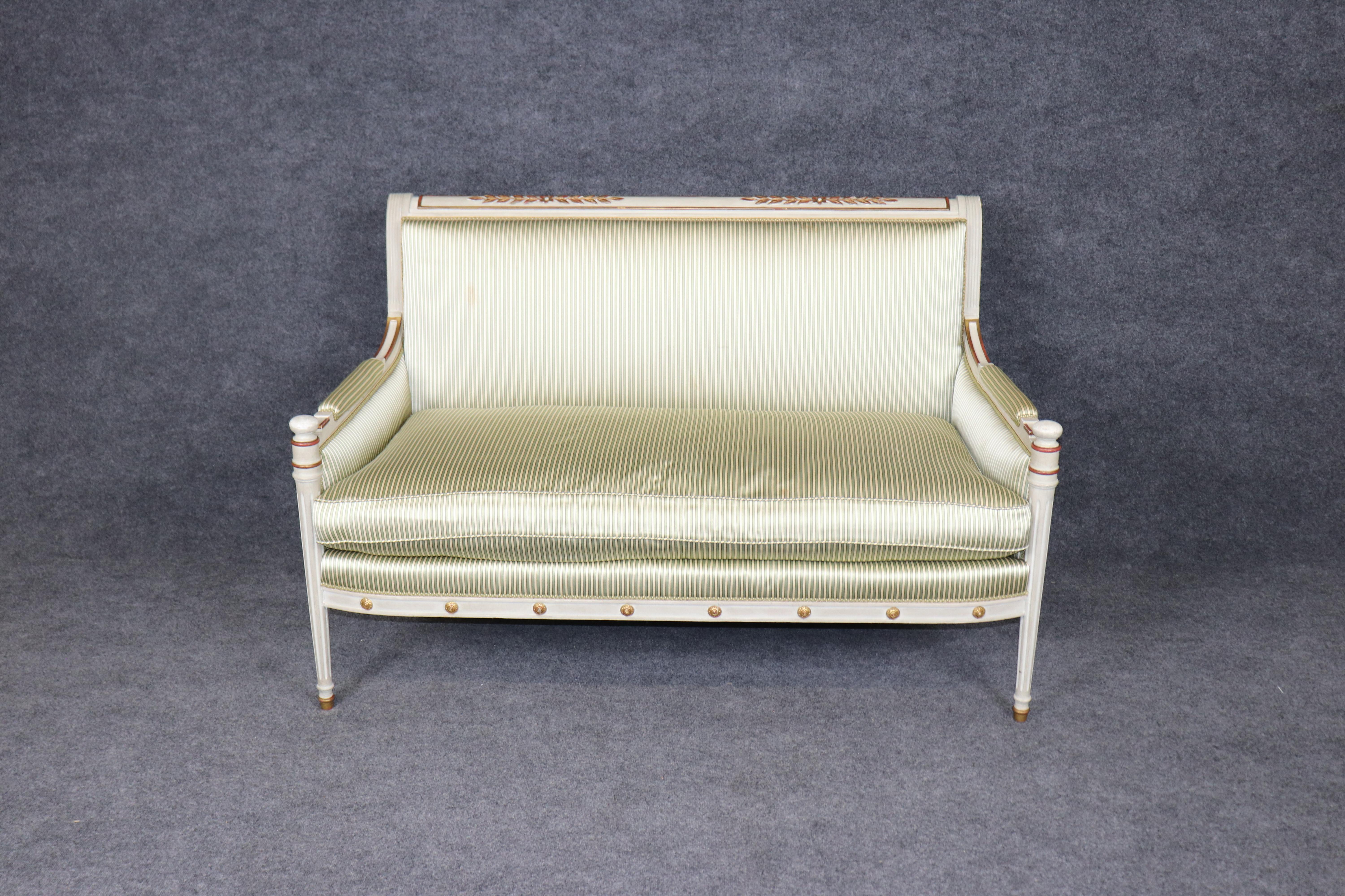 **Maison Jansen (Attributed) French Directoire Style Painted and Gilt Settee, Circa 1920s**

This exquisite **paint-decorated and gilt-accented French Directoire style settee** is attributed to the legendary Parisian design house **Maison Jansen**,