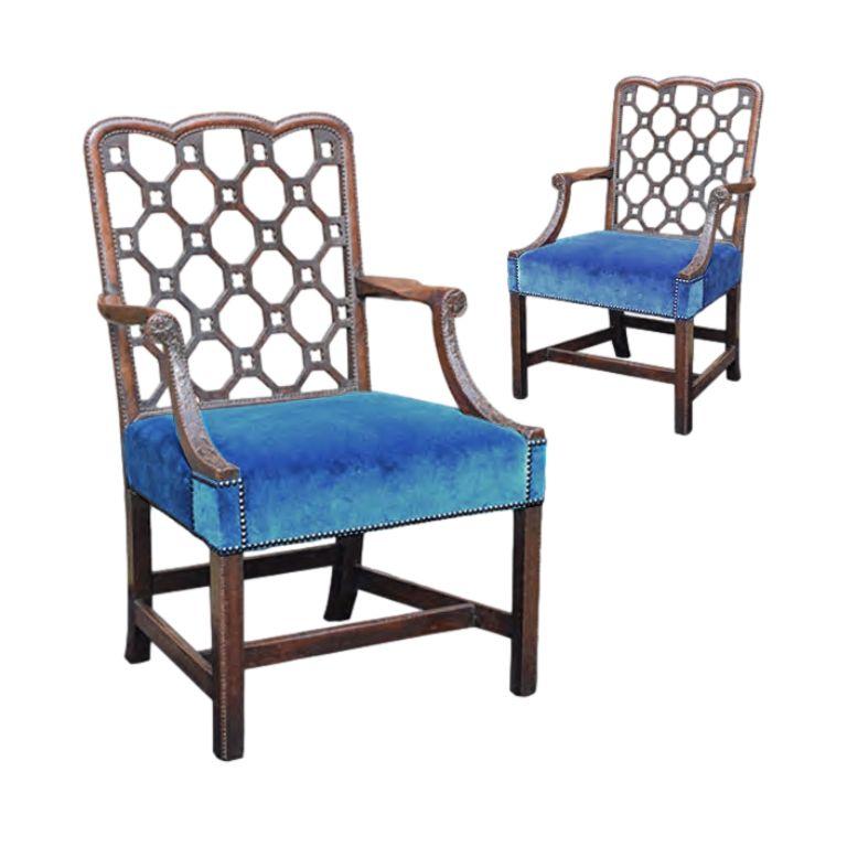 A fine pair of mid-eighteenth century carved mahogany library armchairs in the manner of Robert Manwaring, ca 1760.

Crisply carved, of superb colour and patination throughout. Now covered in blue velvet and close nailed. 'Chinese’ pierced trellis